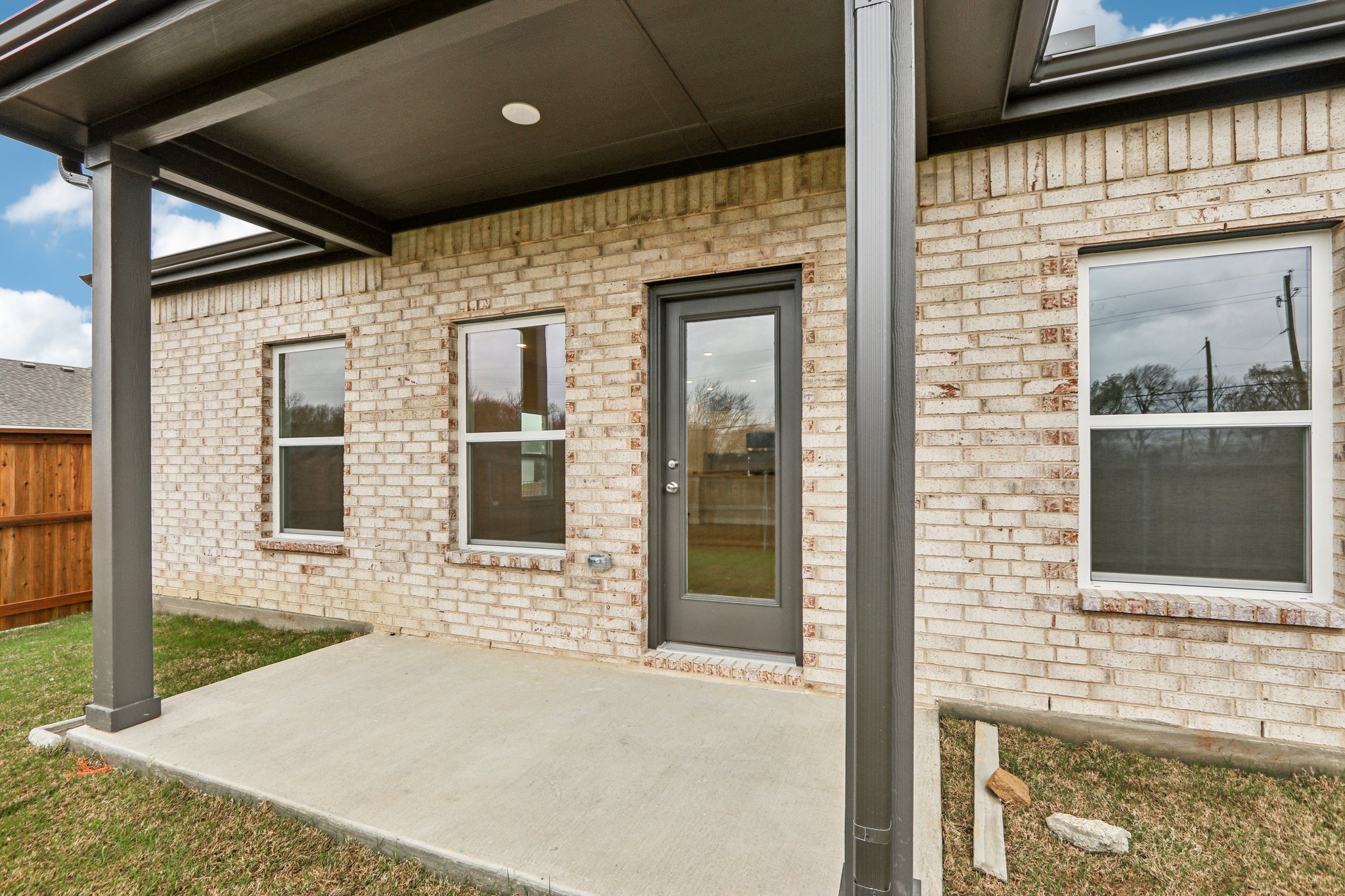 A brick building with a garage door.