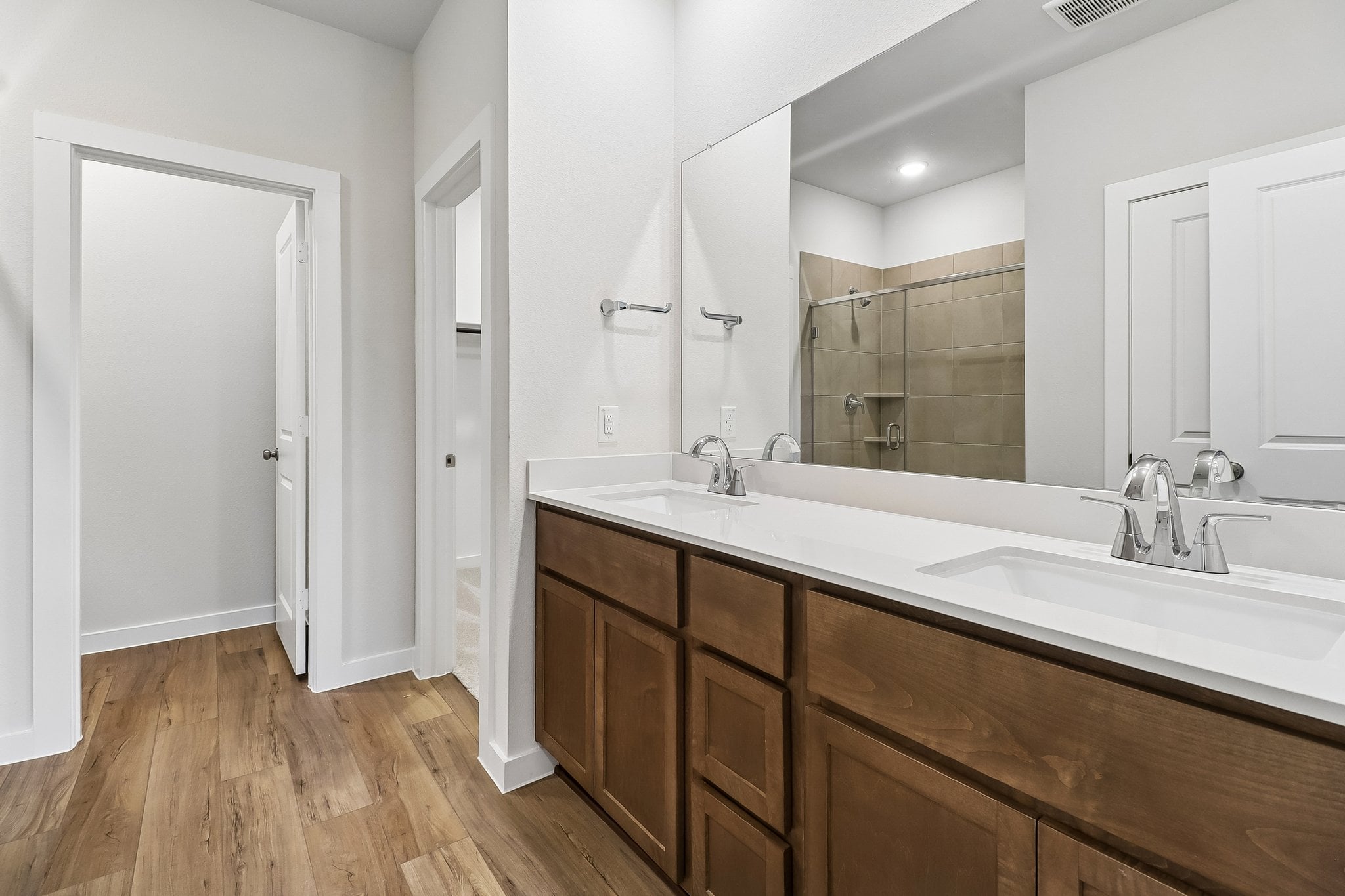 A bathroom with a large mirror.