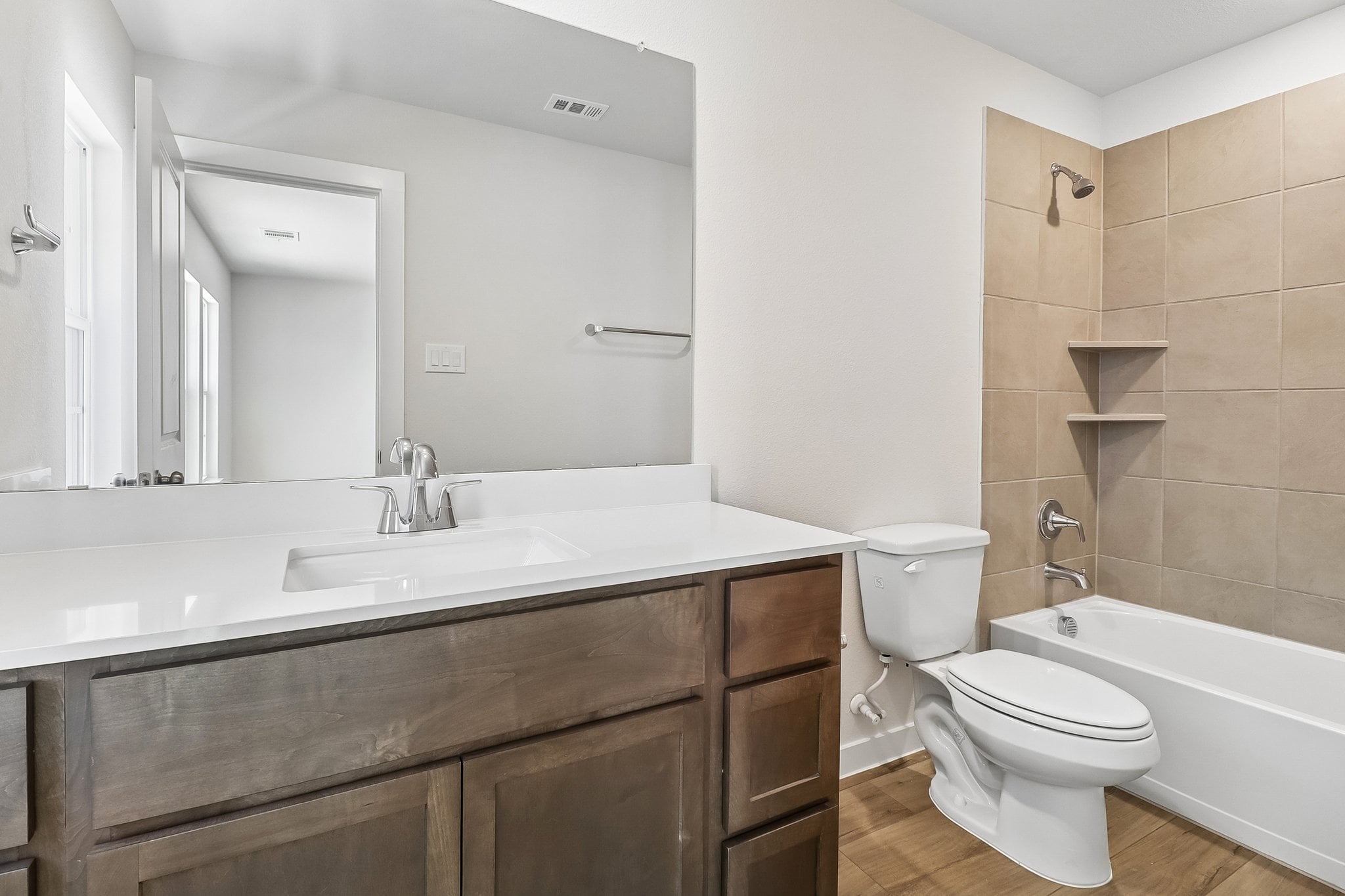 A bathroom with a tub sink and toilet.