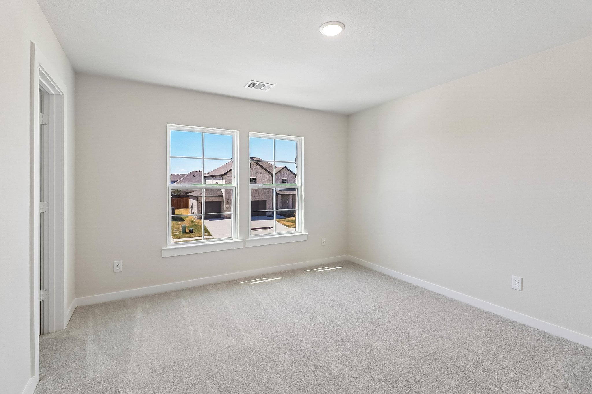 A room with a window and a door.
