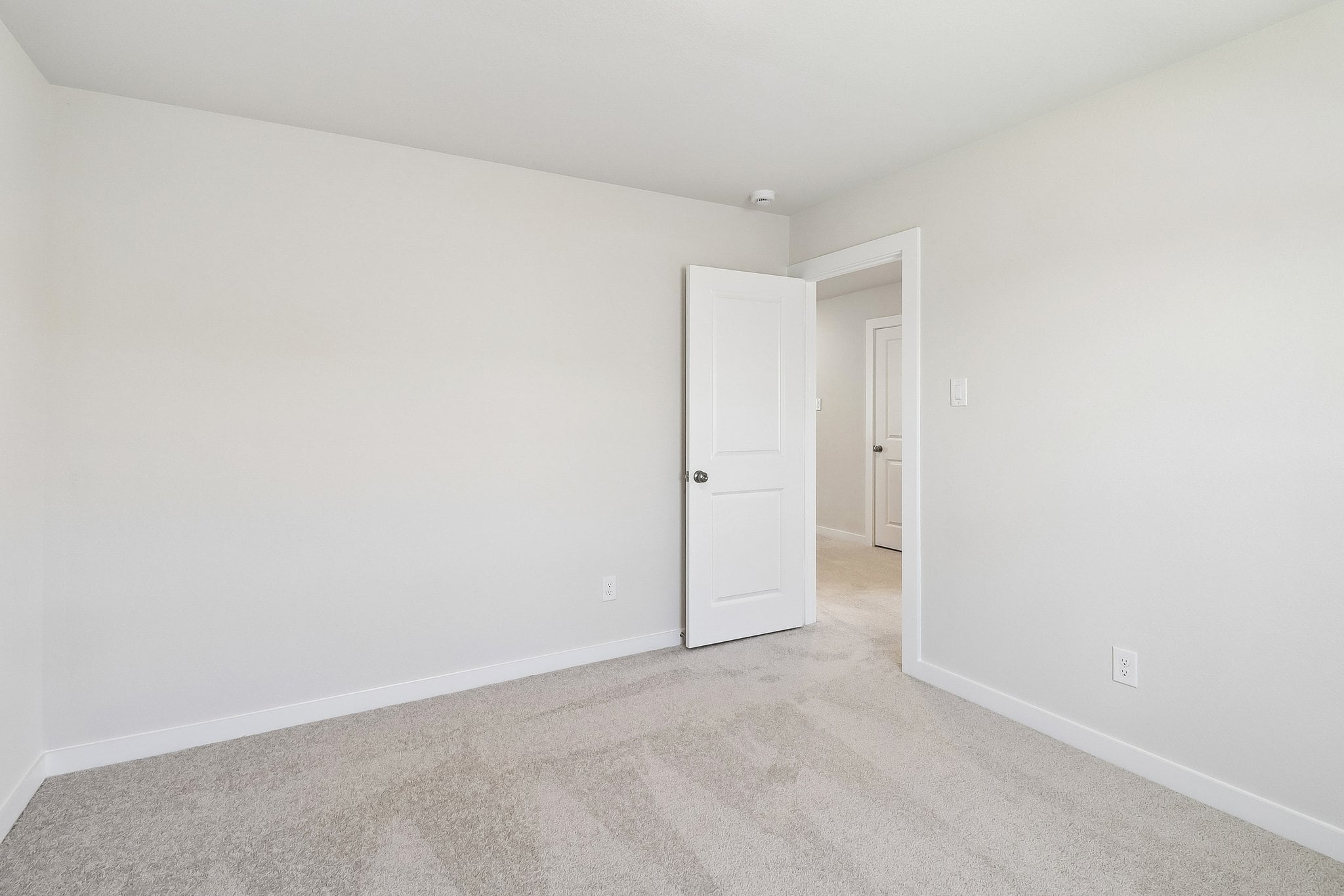 A hallway with white doors.