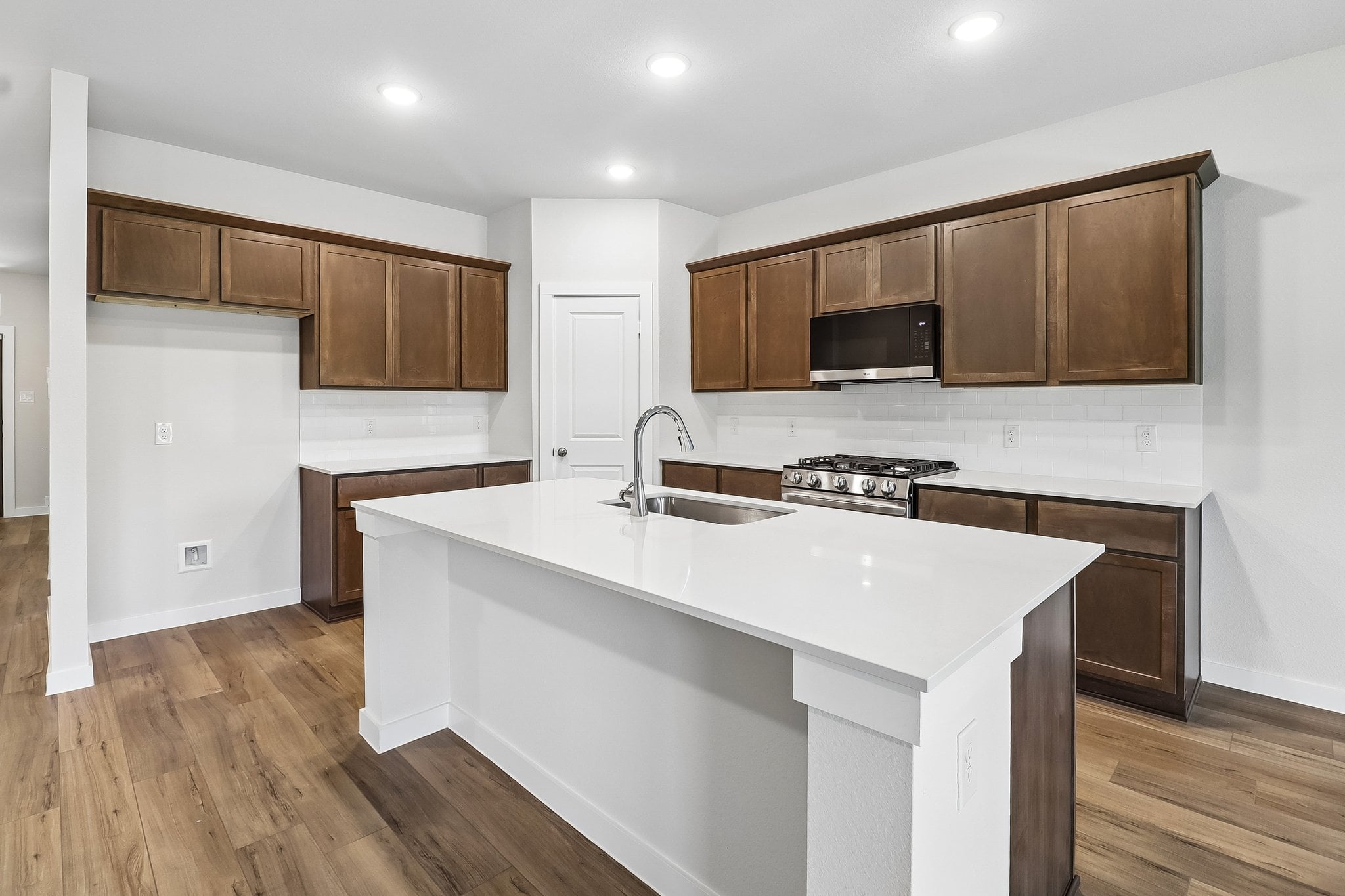 A kitchen with wooden cabinets.