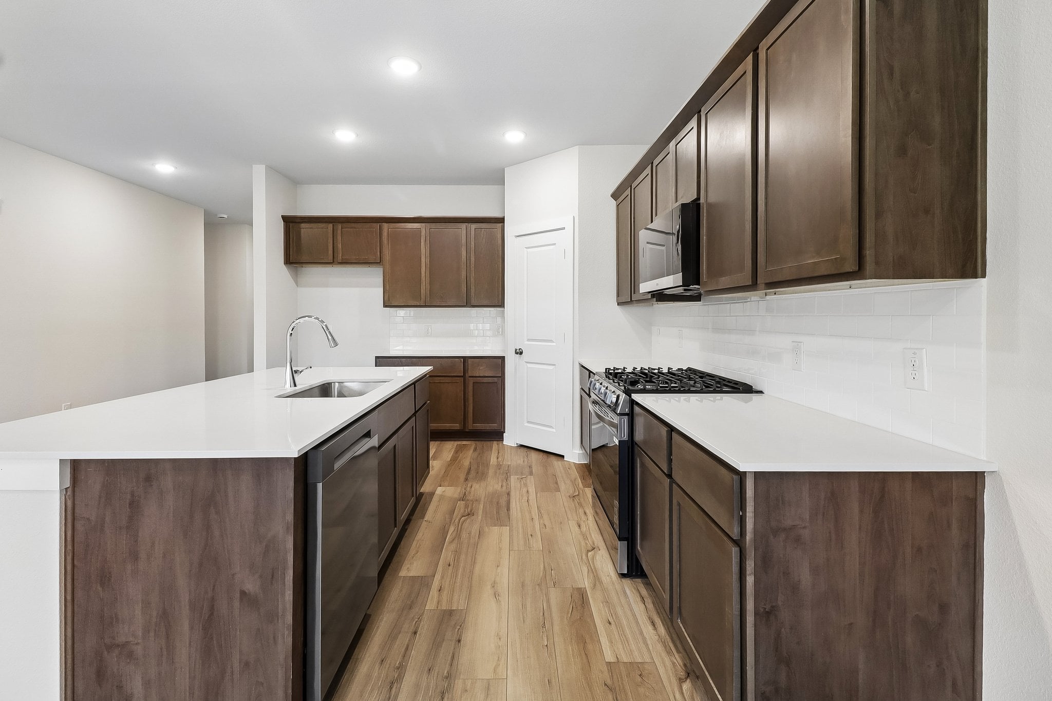 A kitchen with wooden cabinets.
