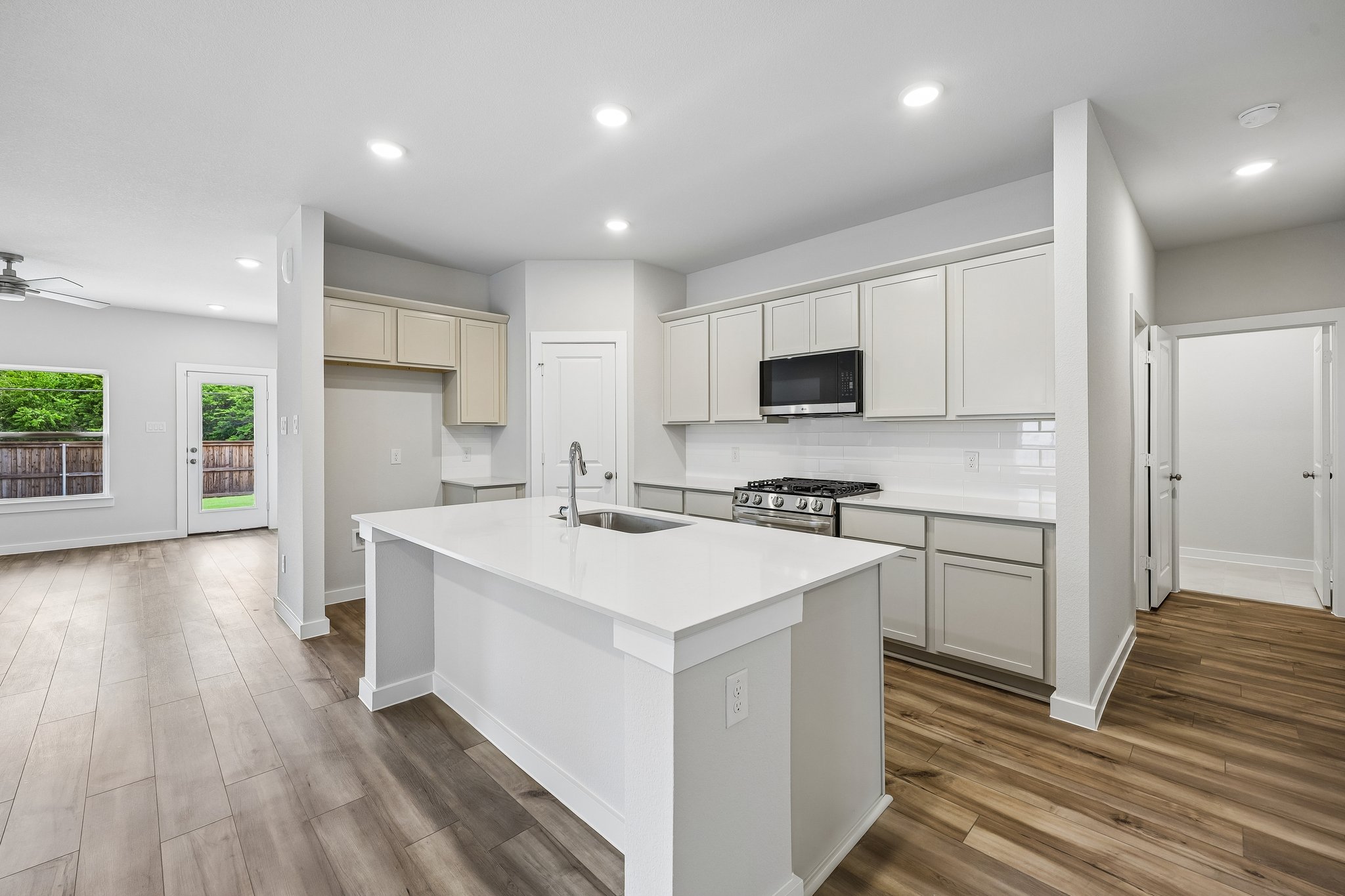 A kitchen with white cabinets.