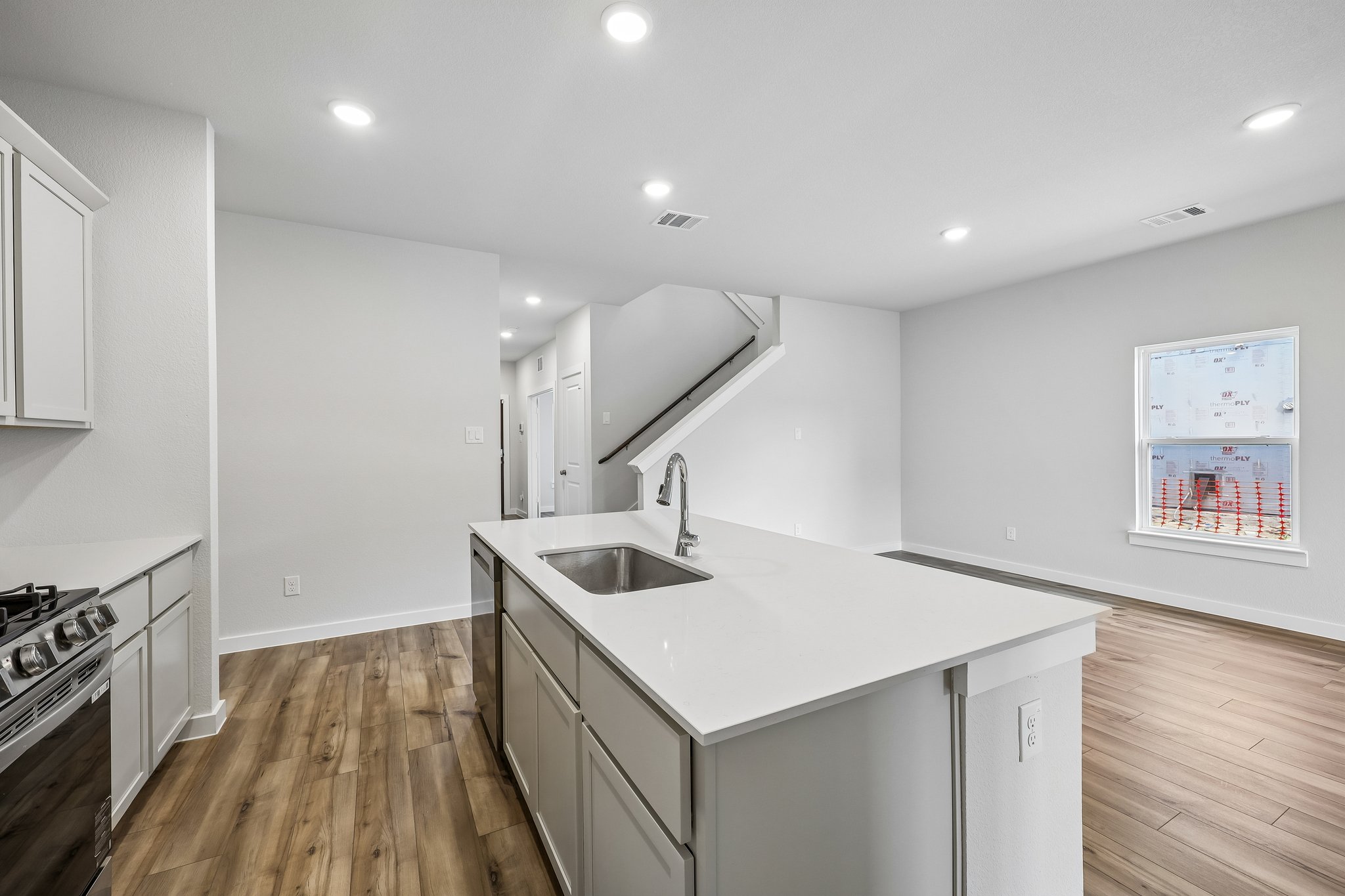 A kitchen with white cabinets.