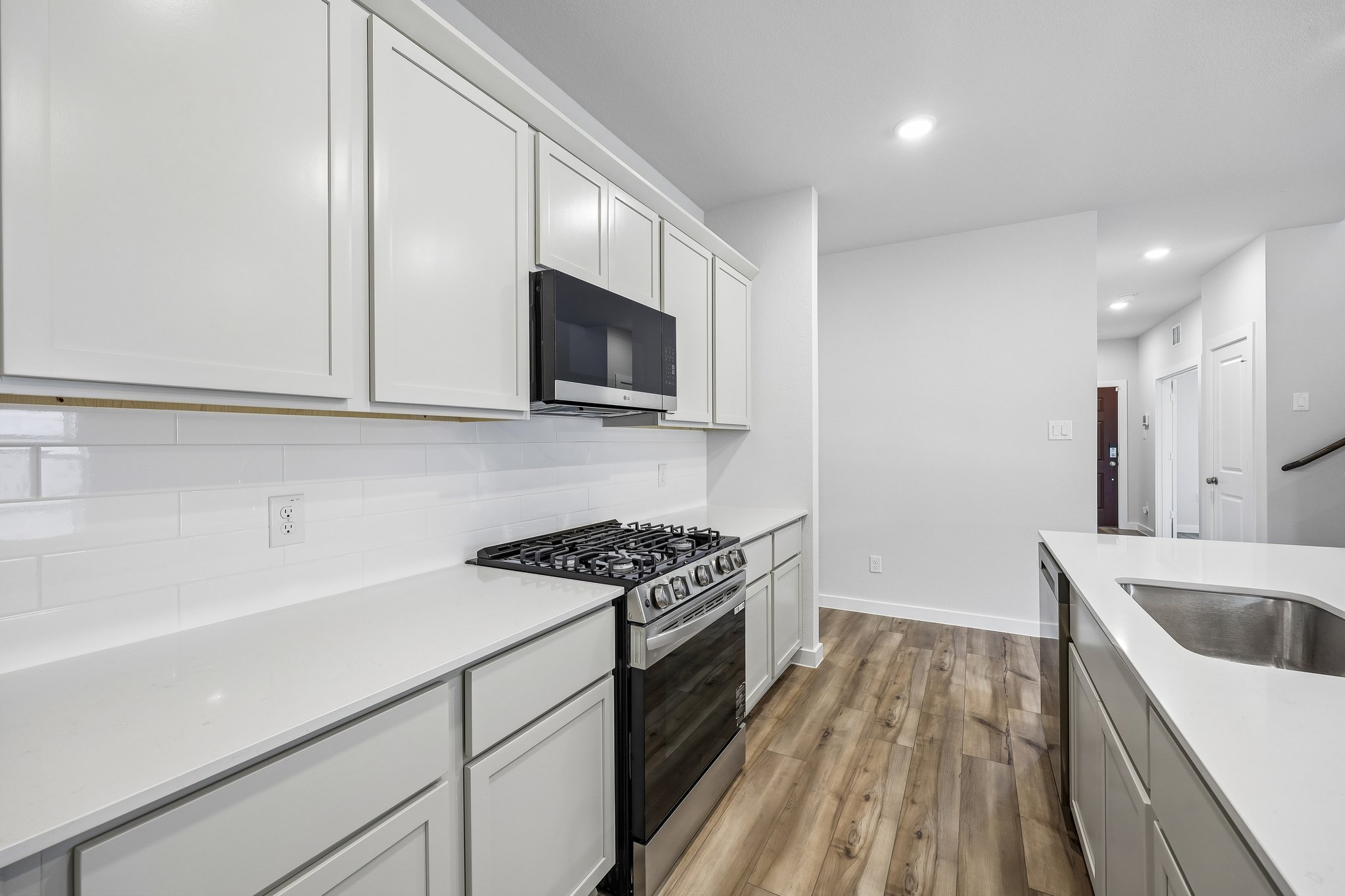 A kitchen with white cabinets.