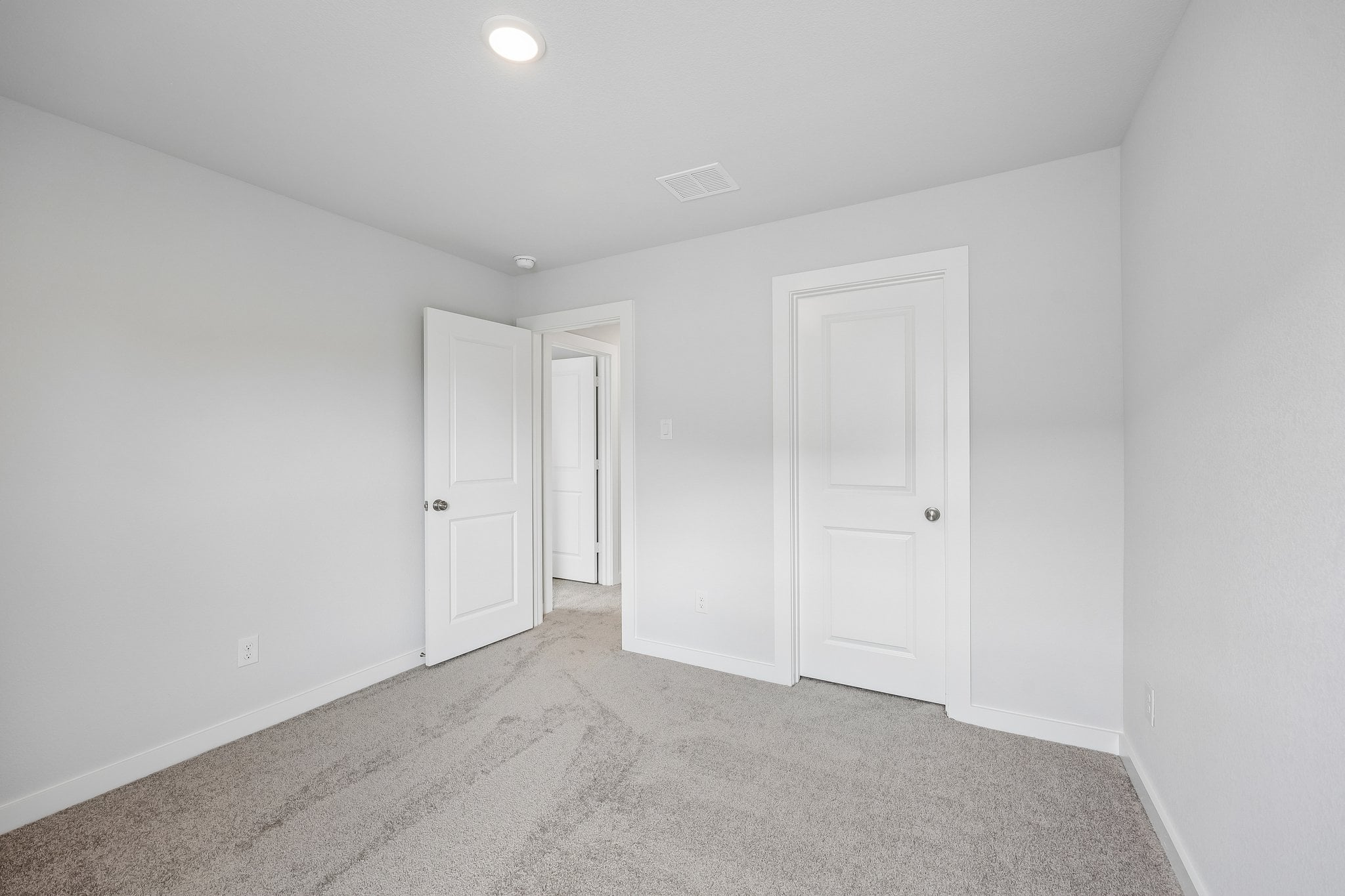 A hallway with white doors.