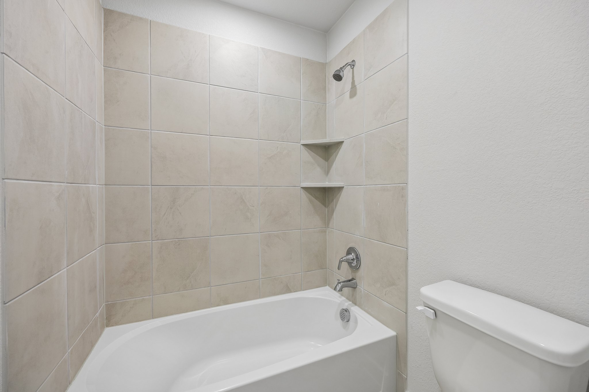A bathtub in a bathroom.