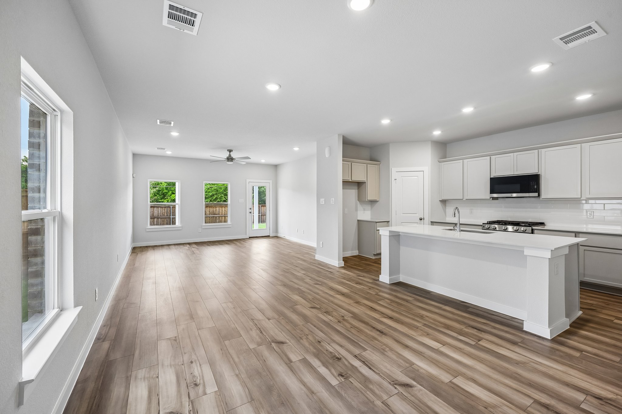 A kitchen with white cabinets.