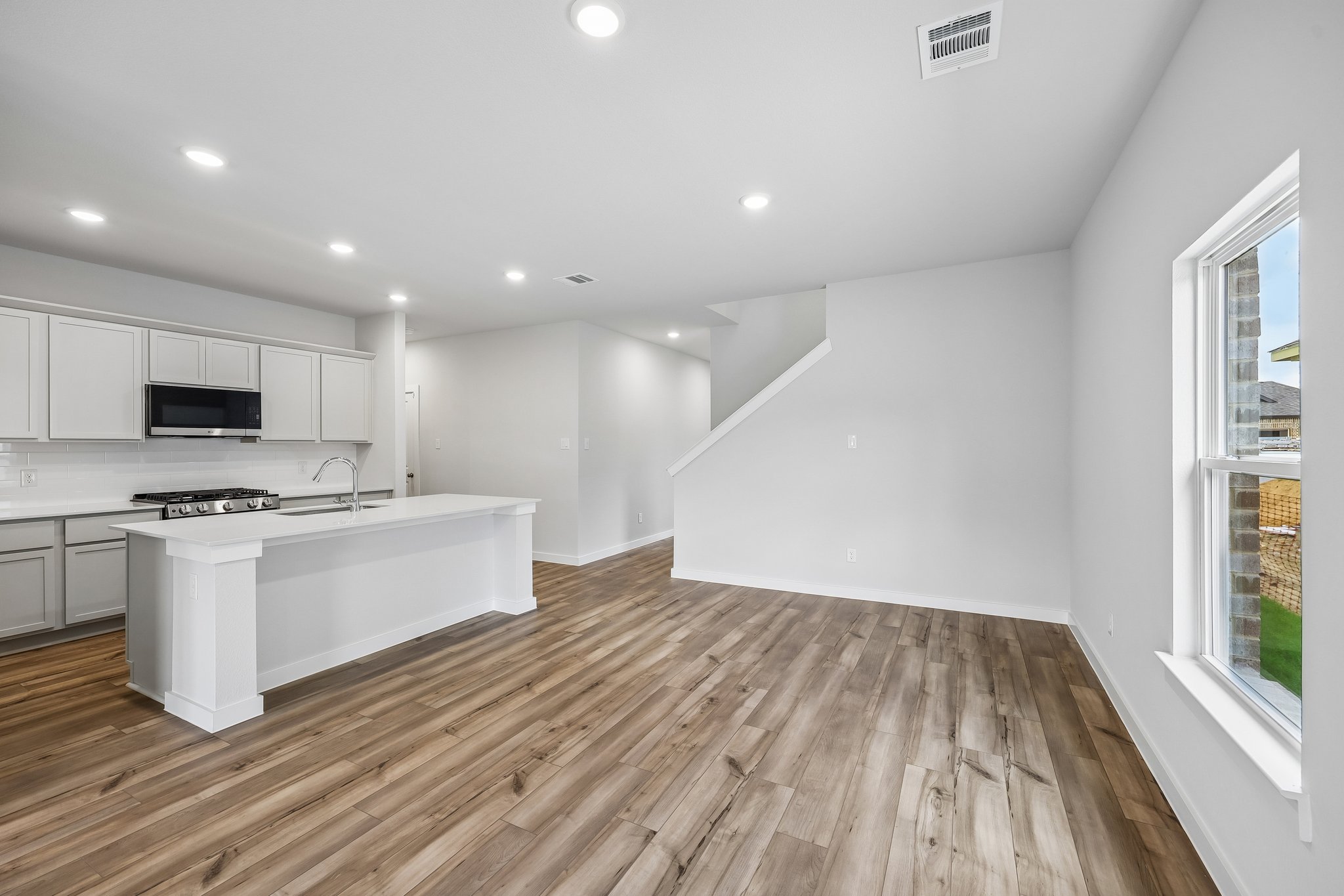 A kitchen with white cabinets.