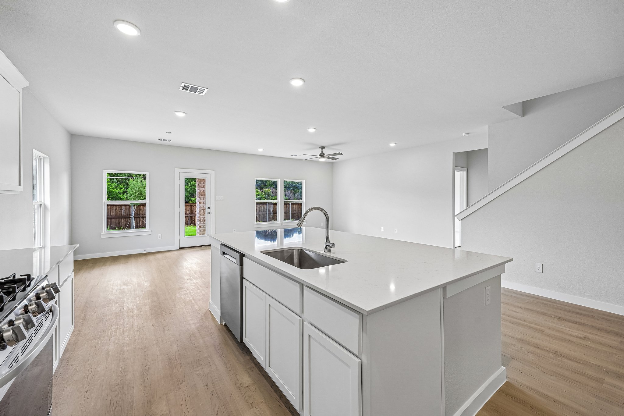 A kitchen with white cabinets.