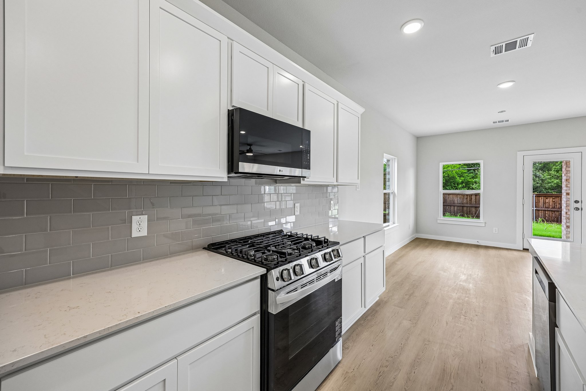 A kitchen with white cabinets.