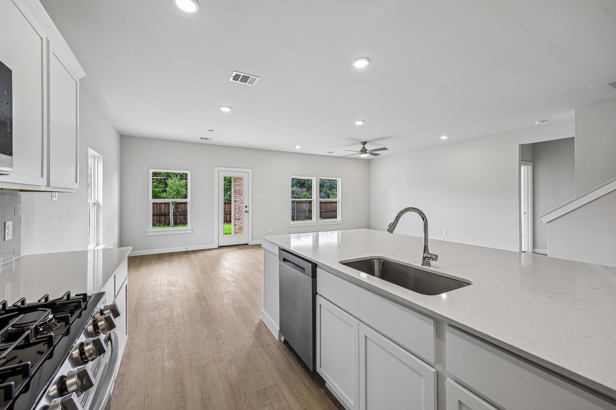 A kitchen with white cabinets.