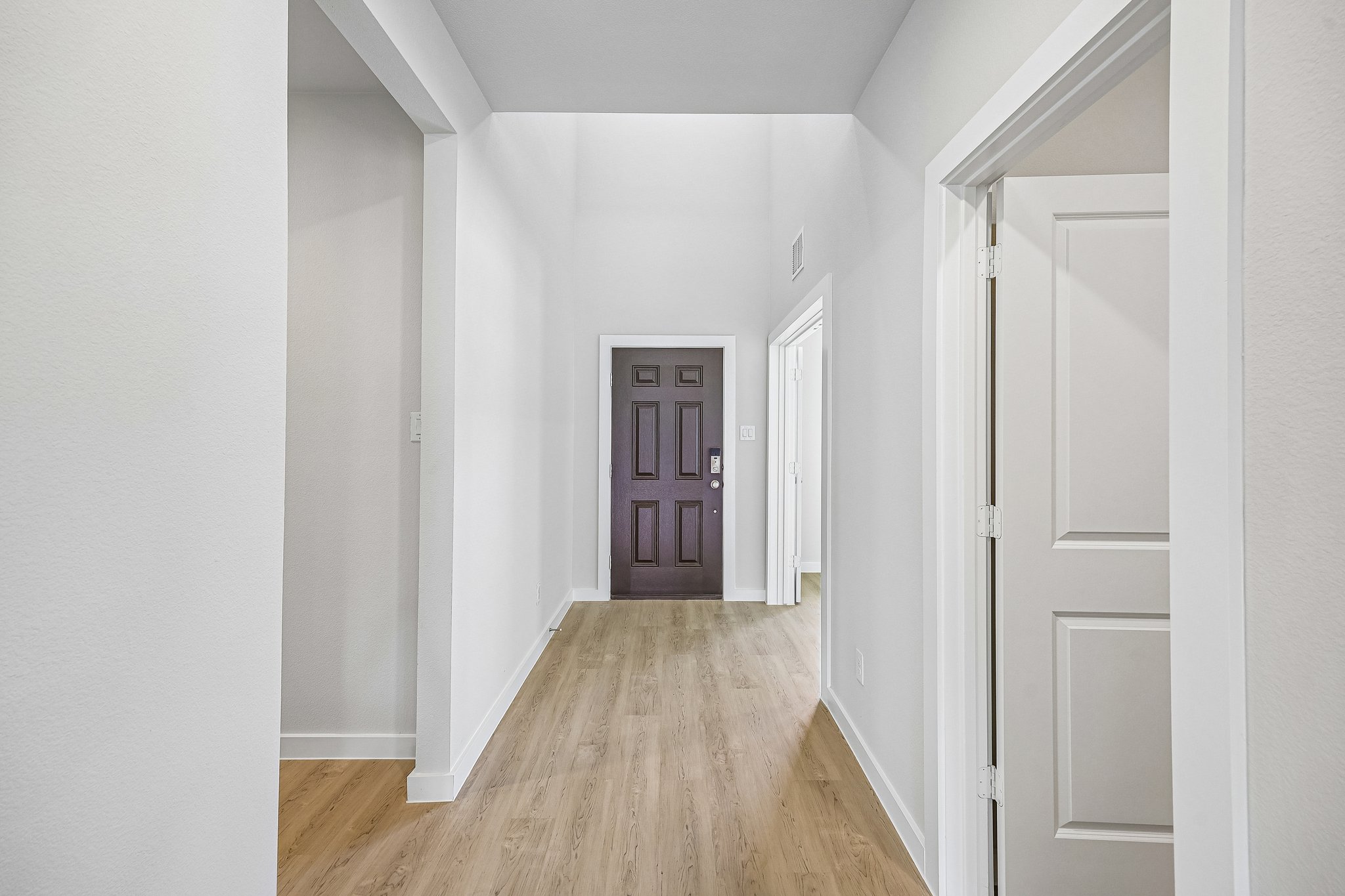 A hallway with white walls.