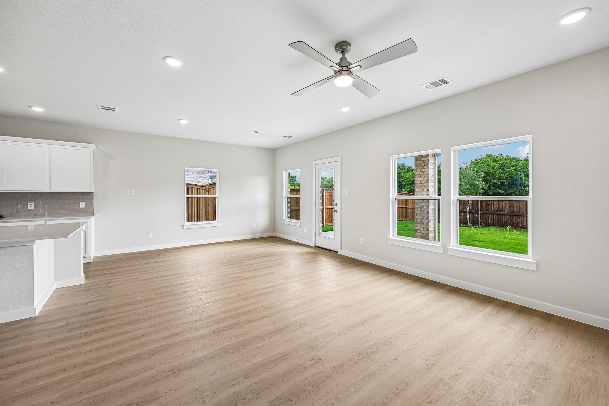 A large kitchen with a wood floor.