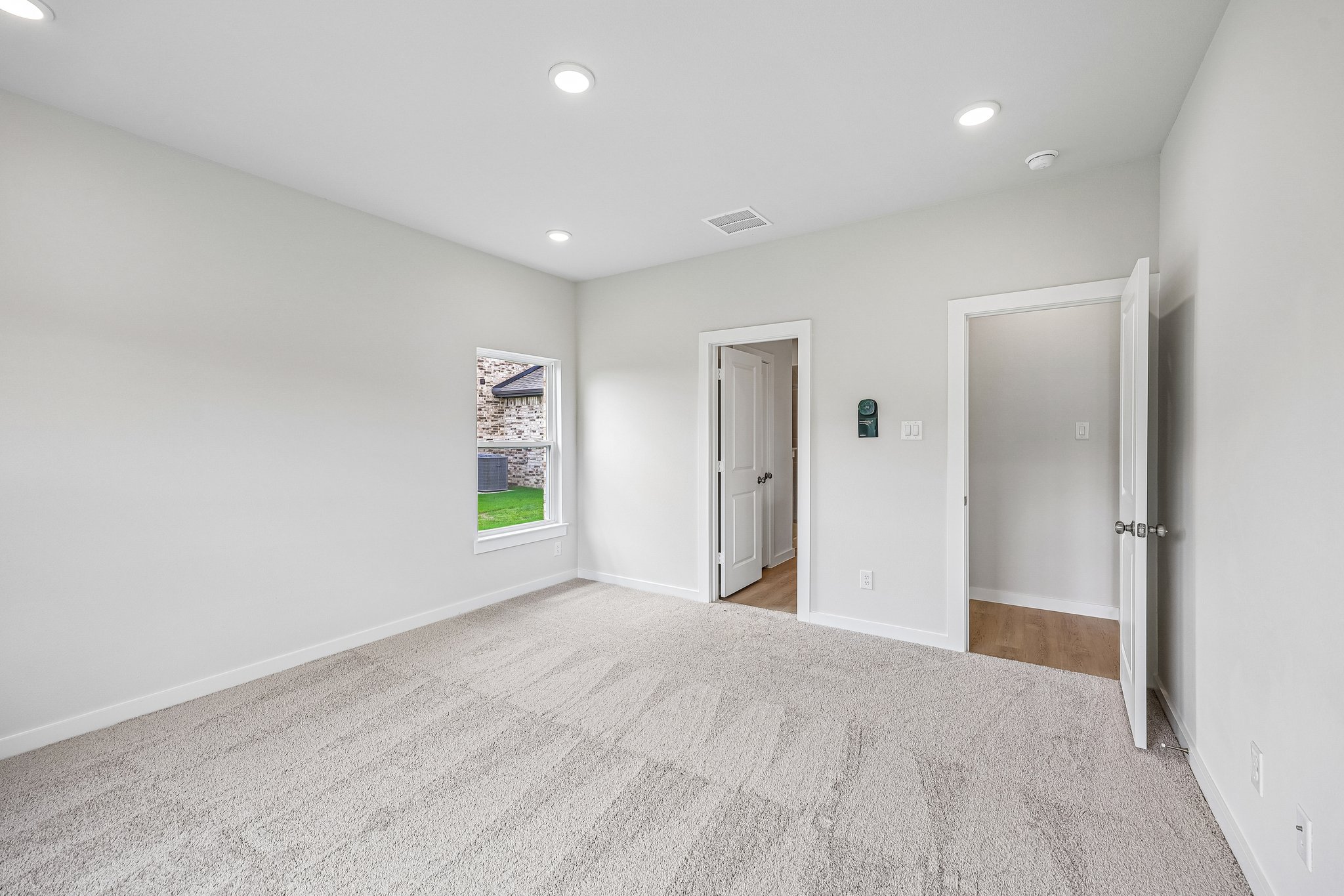 A hallway with white walls.