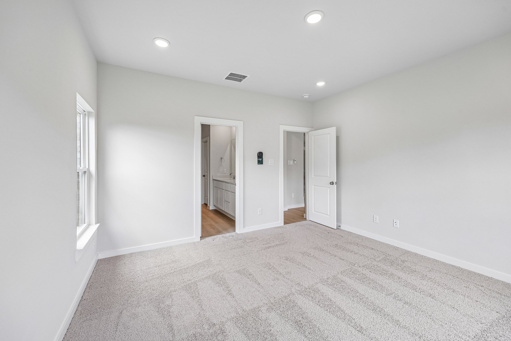 A hallway with white walls.