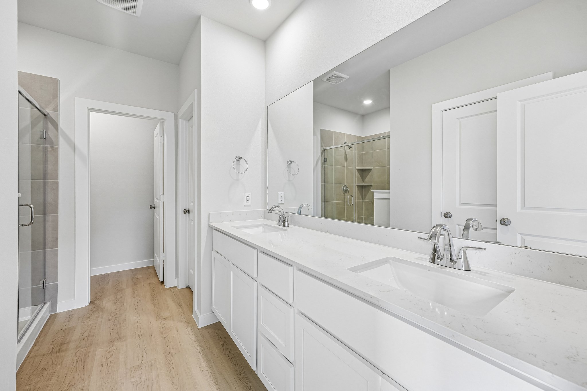 A bathroom with white cabinets.