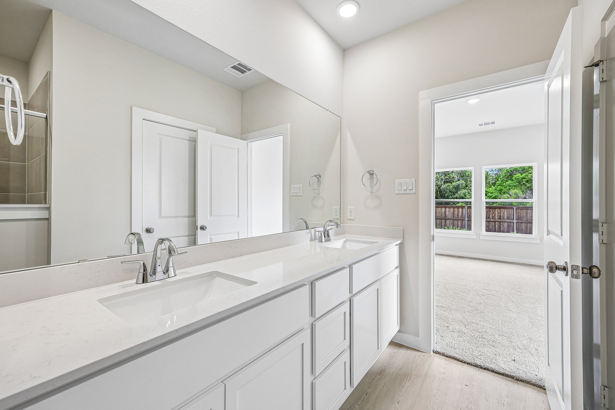 A bathroom with a large mirror.