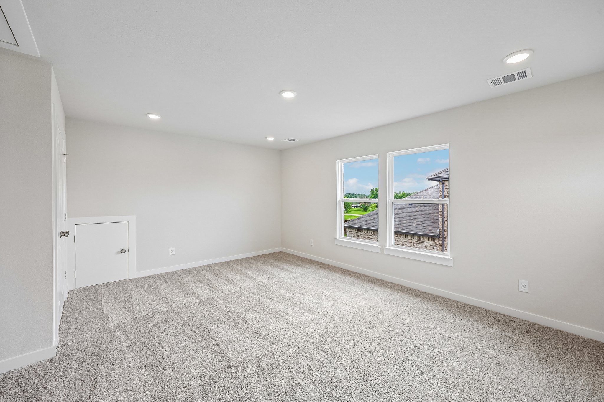 A room with a window and a door.