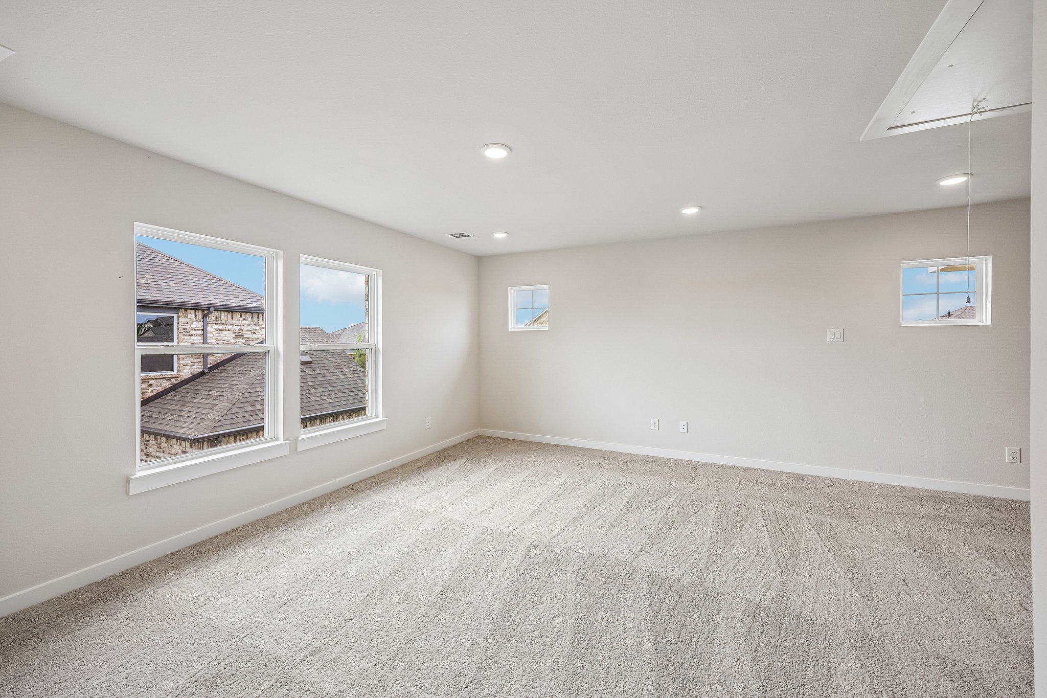 A room with a window and a rug.