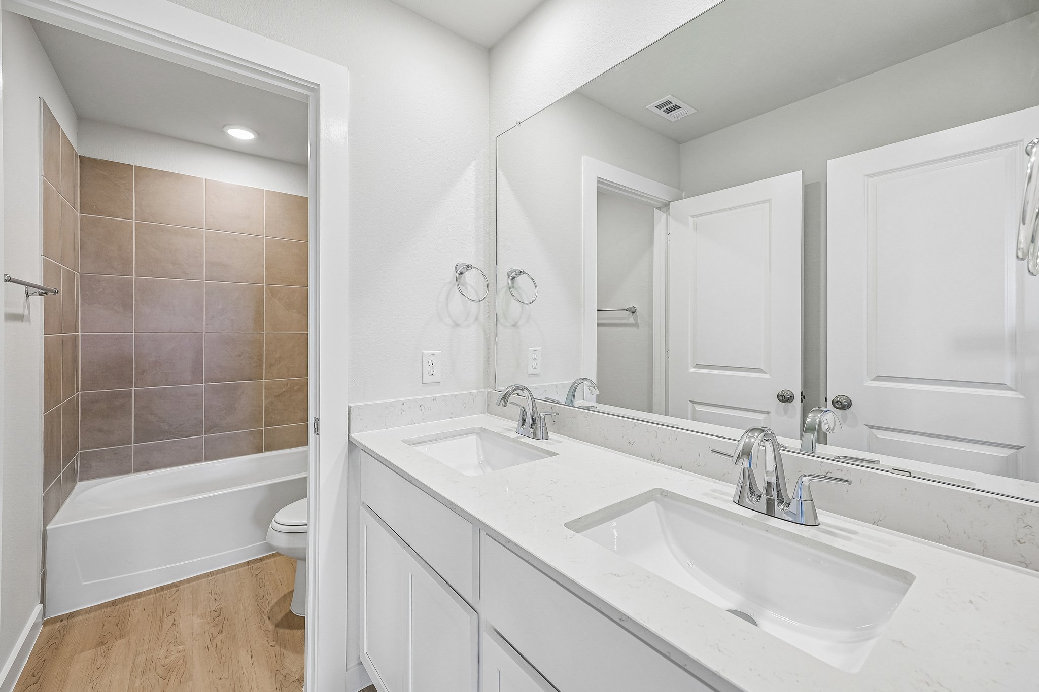 A bathroom with a tub sink and a toilet.