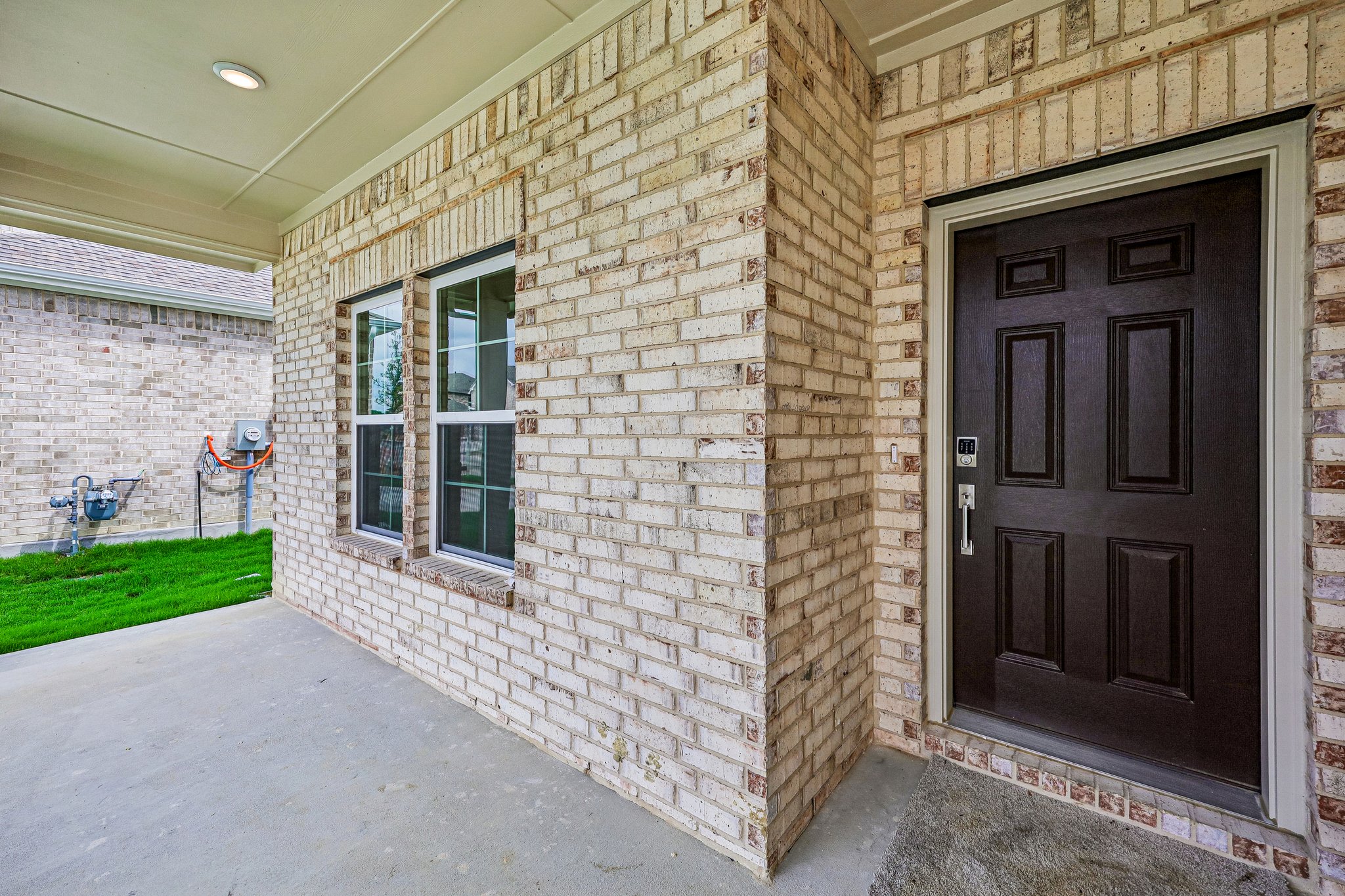 A brick building with a black door.