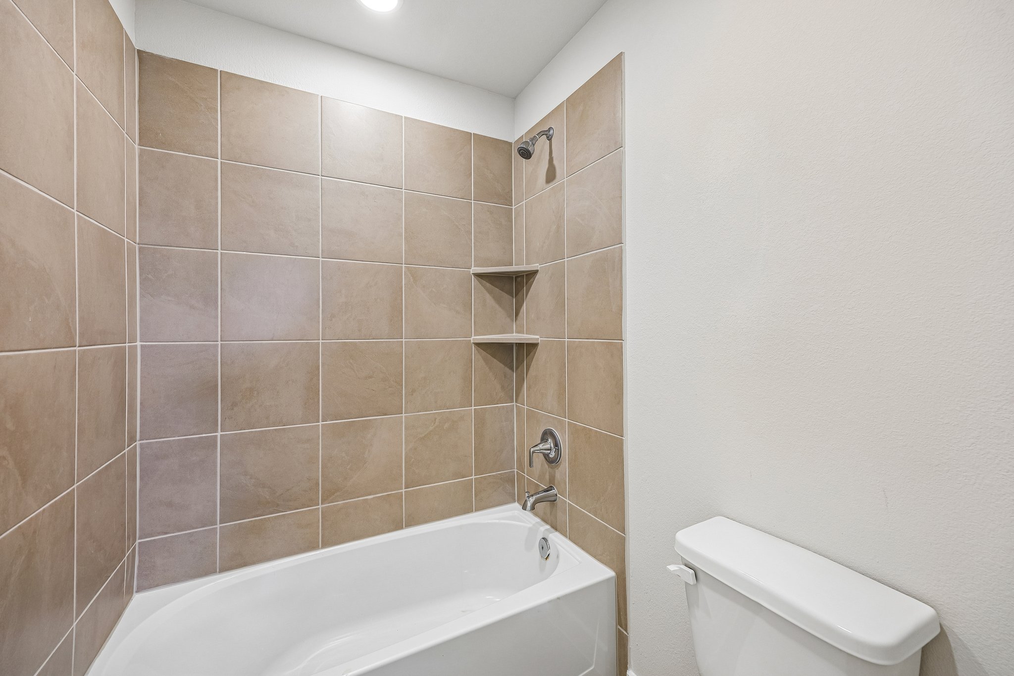 A bathroom with a bathtub and toilet.