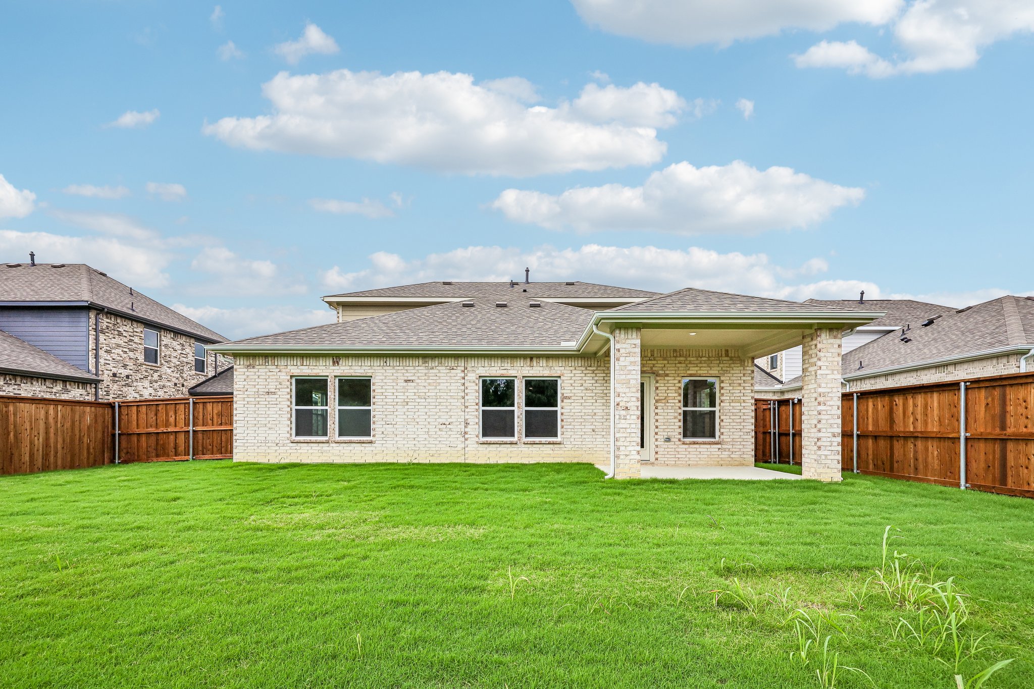 A house with a fence and grass.