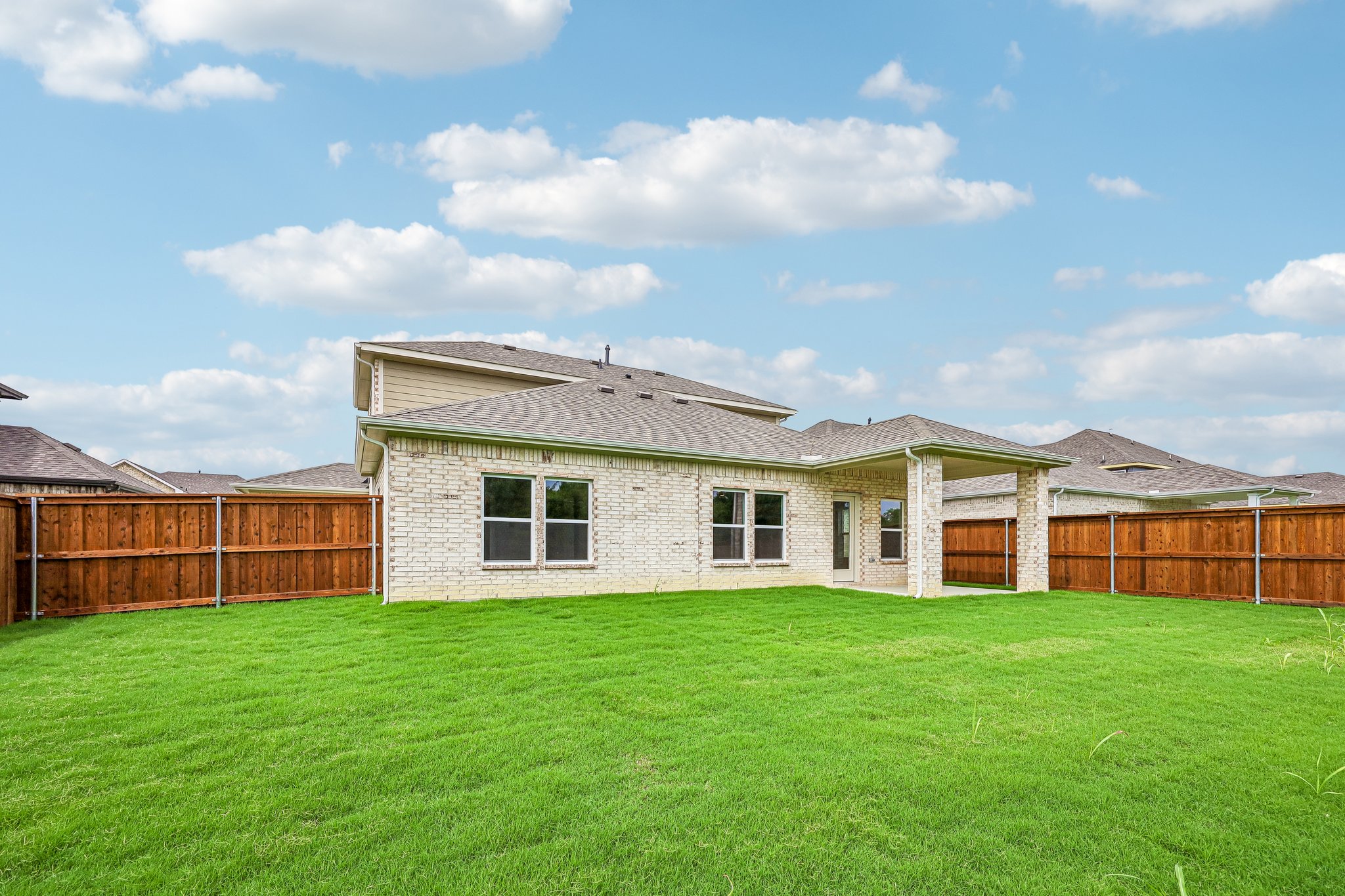 A house with a grass yard.