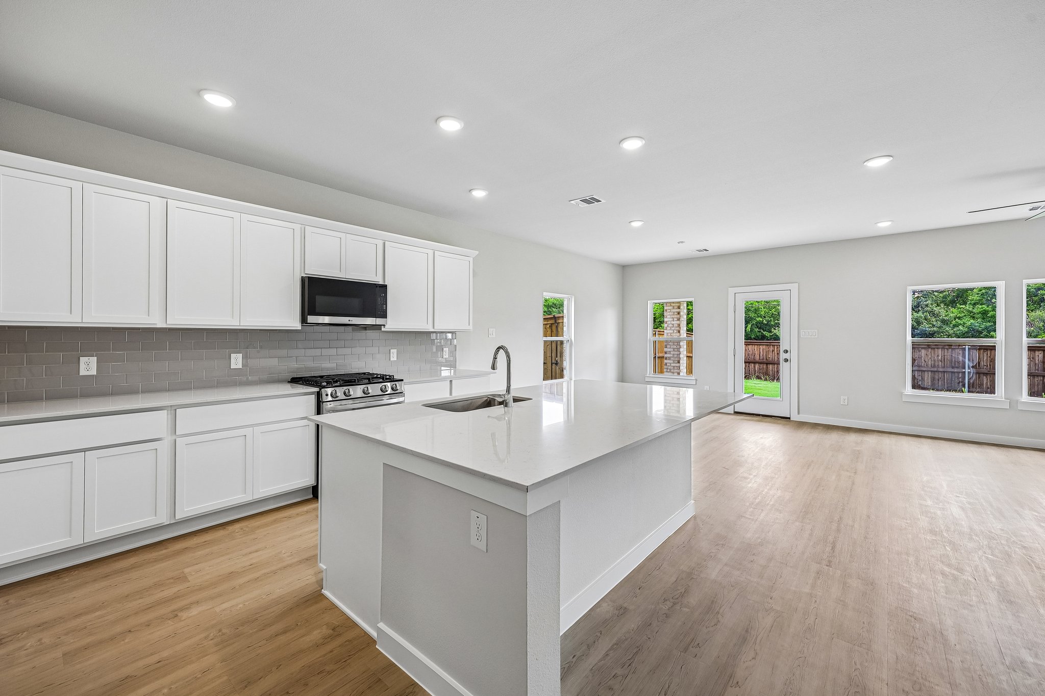 A kitchen with white cabinets.