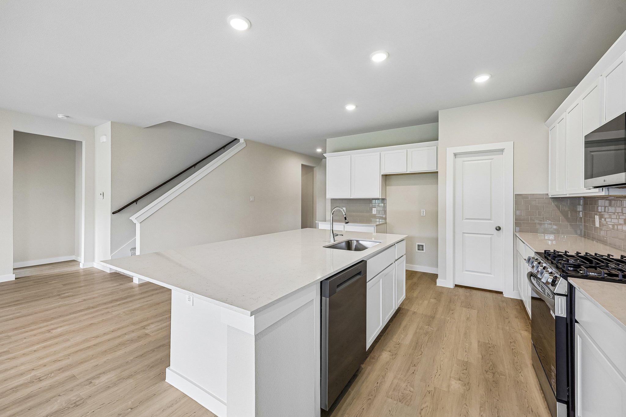 A kitchen with white cabinets.