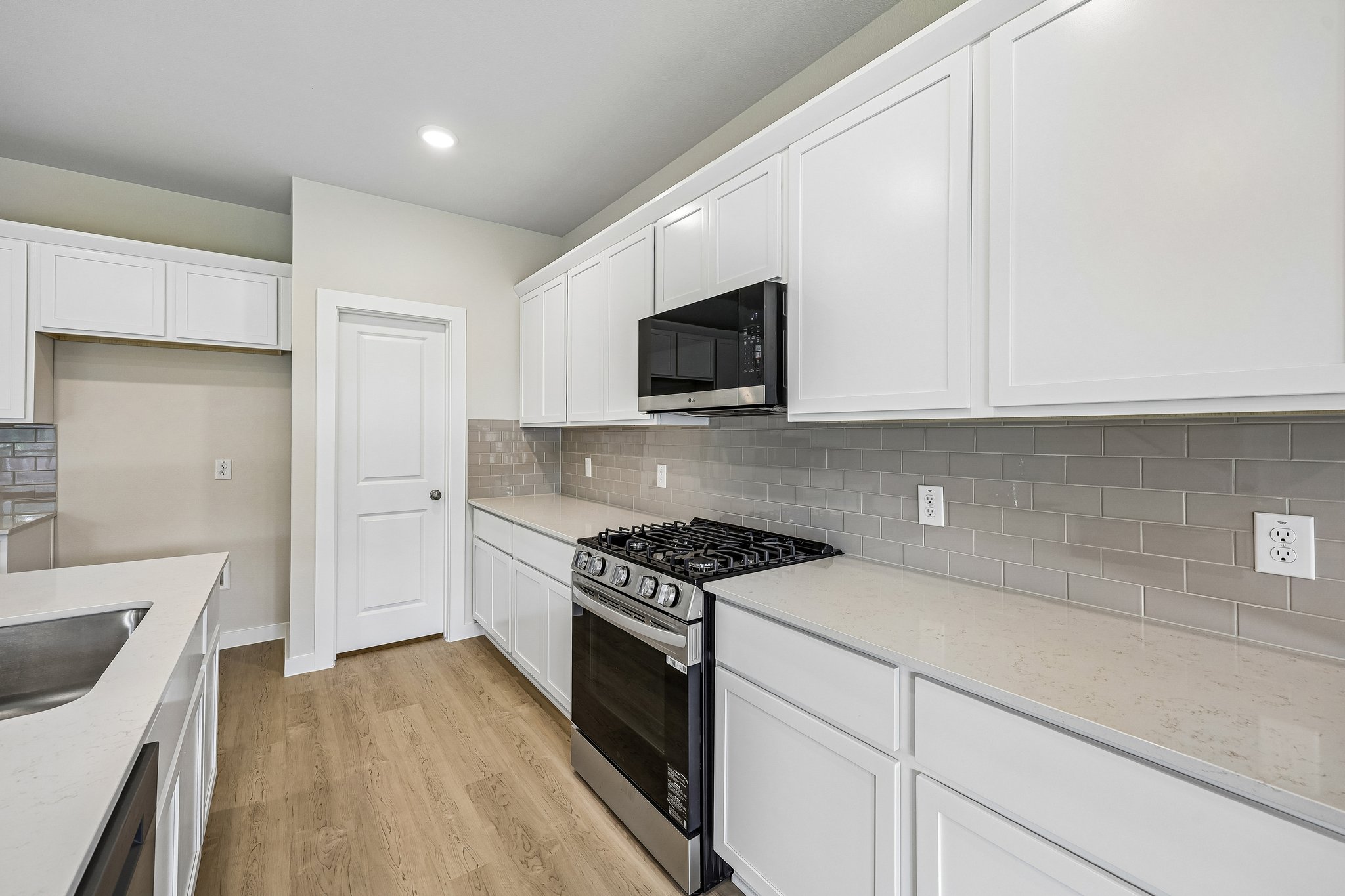 A kitchen with white cabinets.