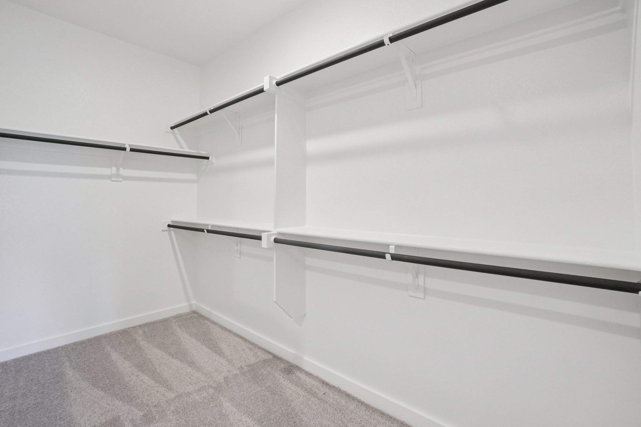 A white wall with a metal railing.