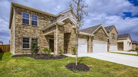 A house with a tree in the front yard.
