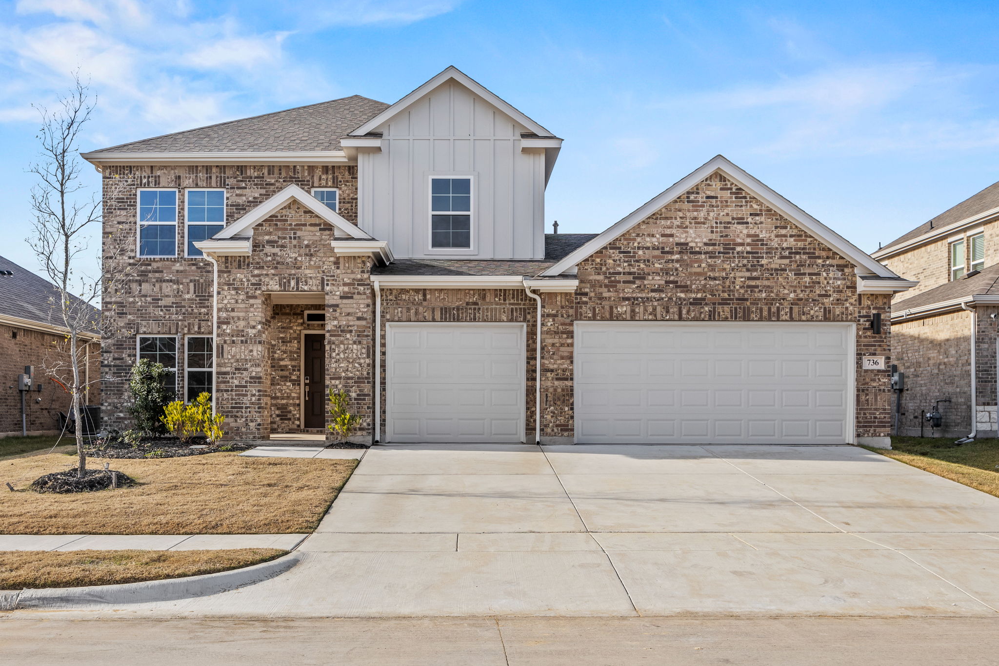 A house with garages and a driveway.