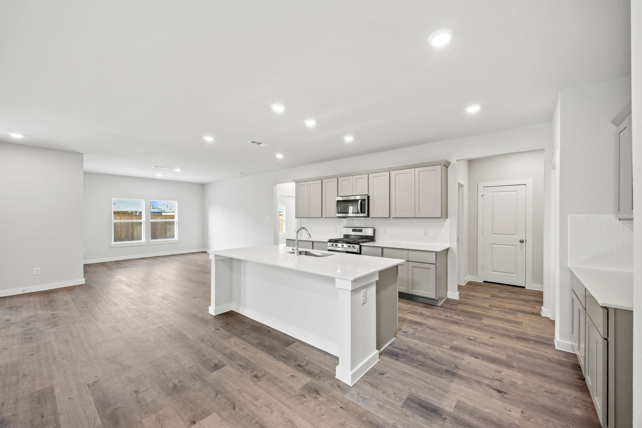 A kitchen with white cabinets.