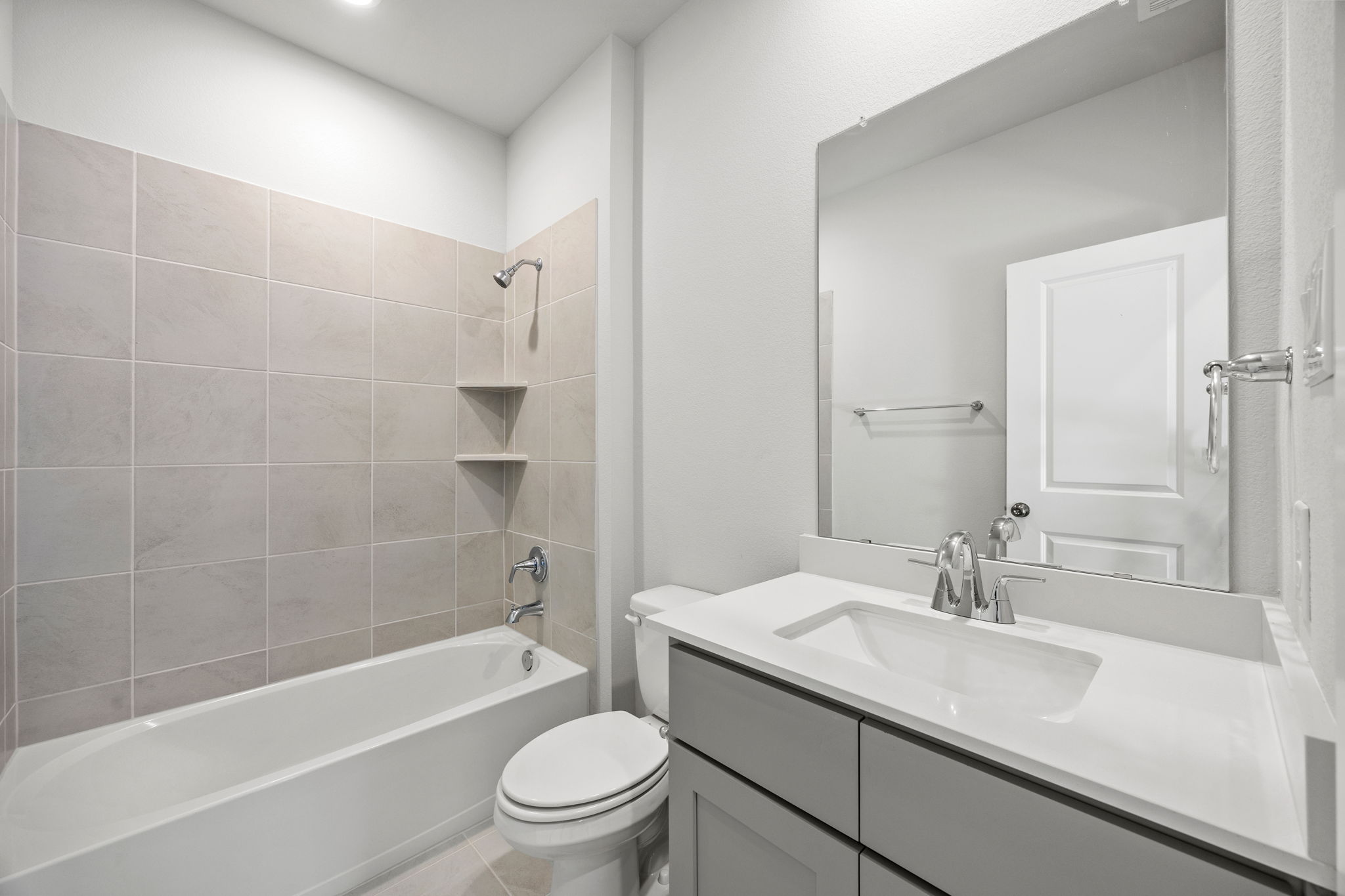 A bathroom with a tub sink and toilet.