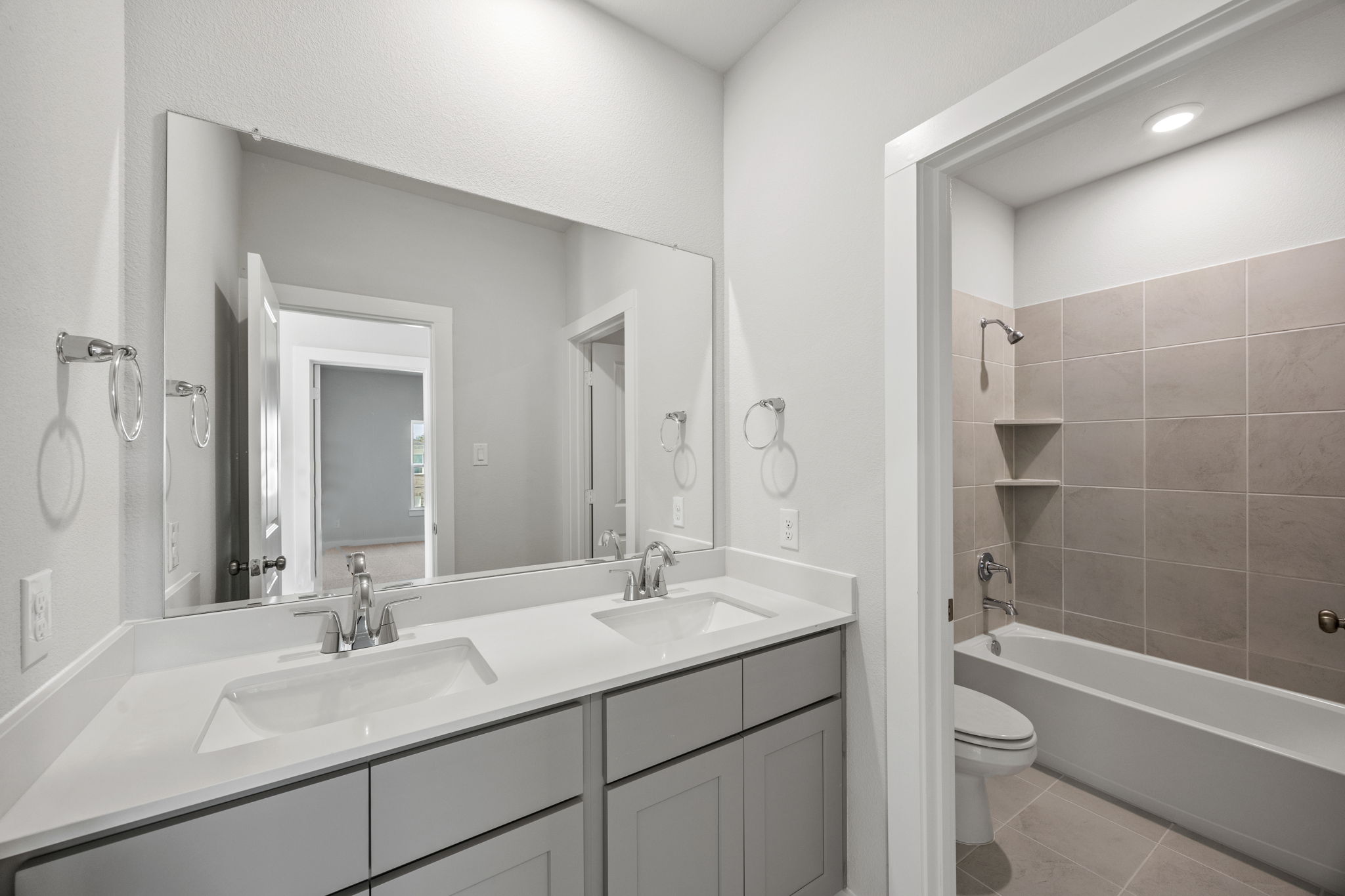 A bathroom with a tub sink and toilet.