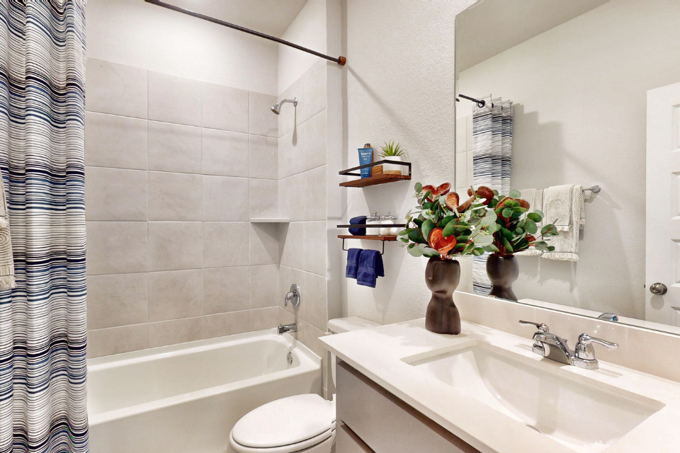 A bathroom with a sink and a mirror.