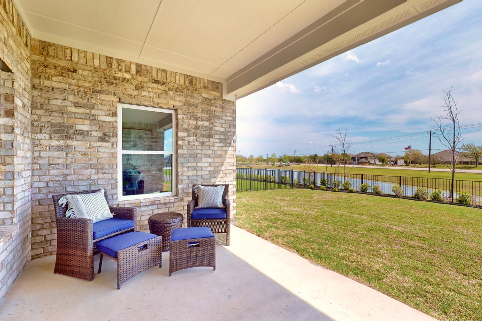 A patio with chairs and a table.
