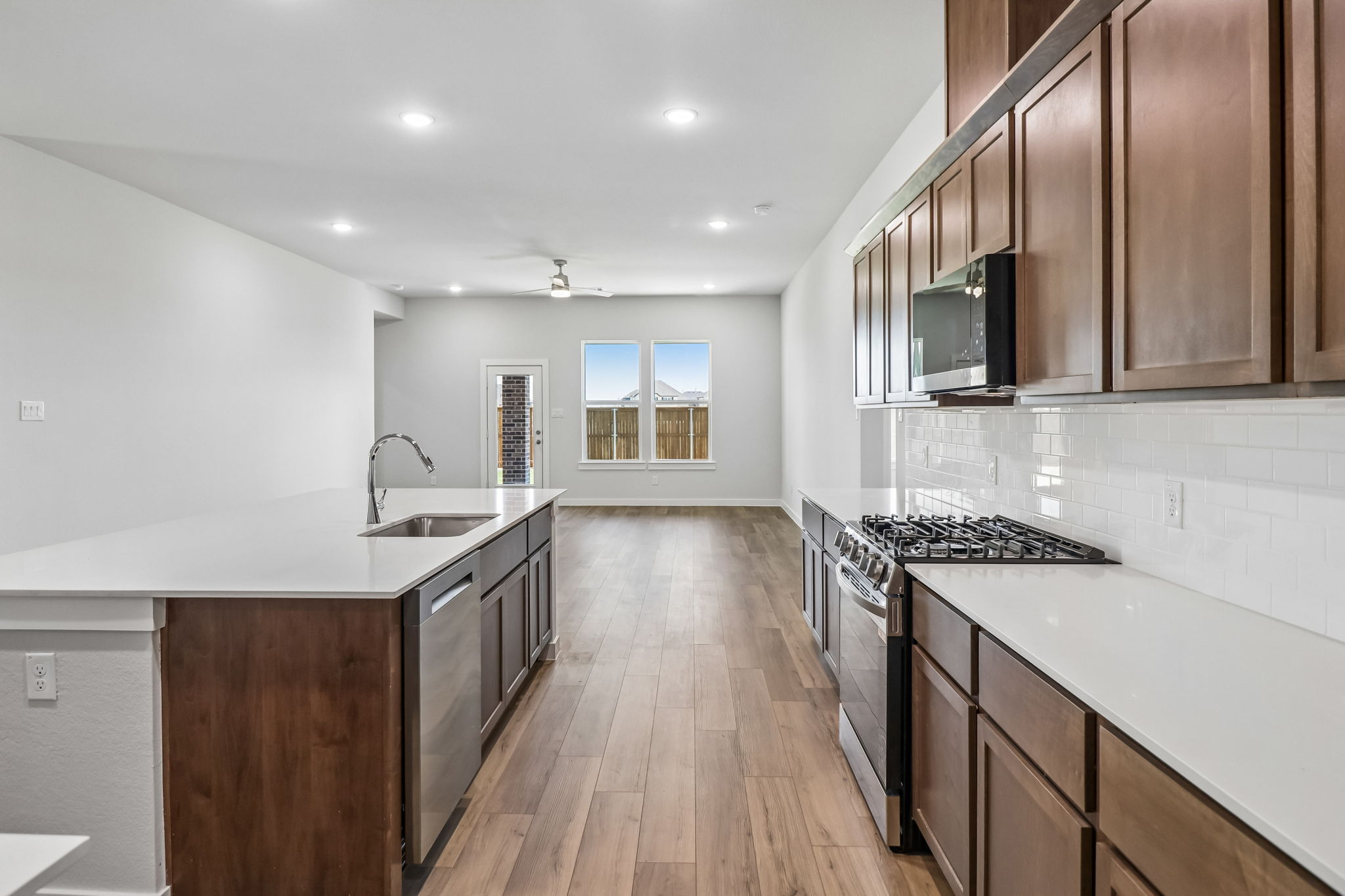 A kitchen with wooden cabinets.