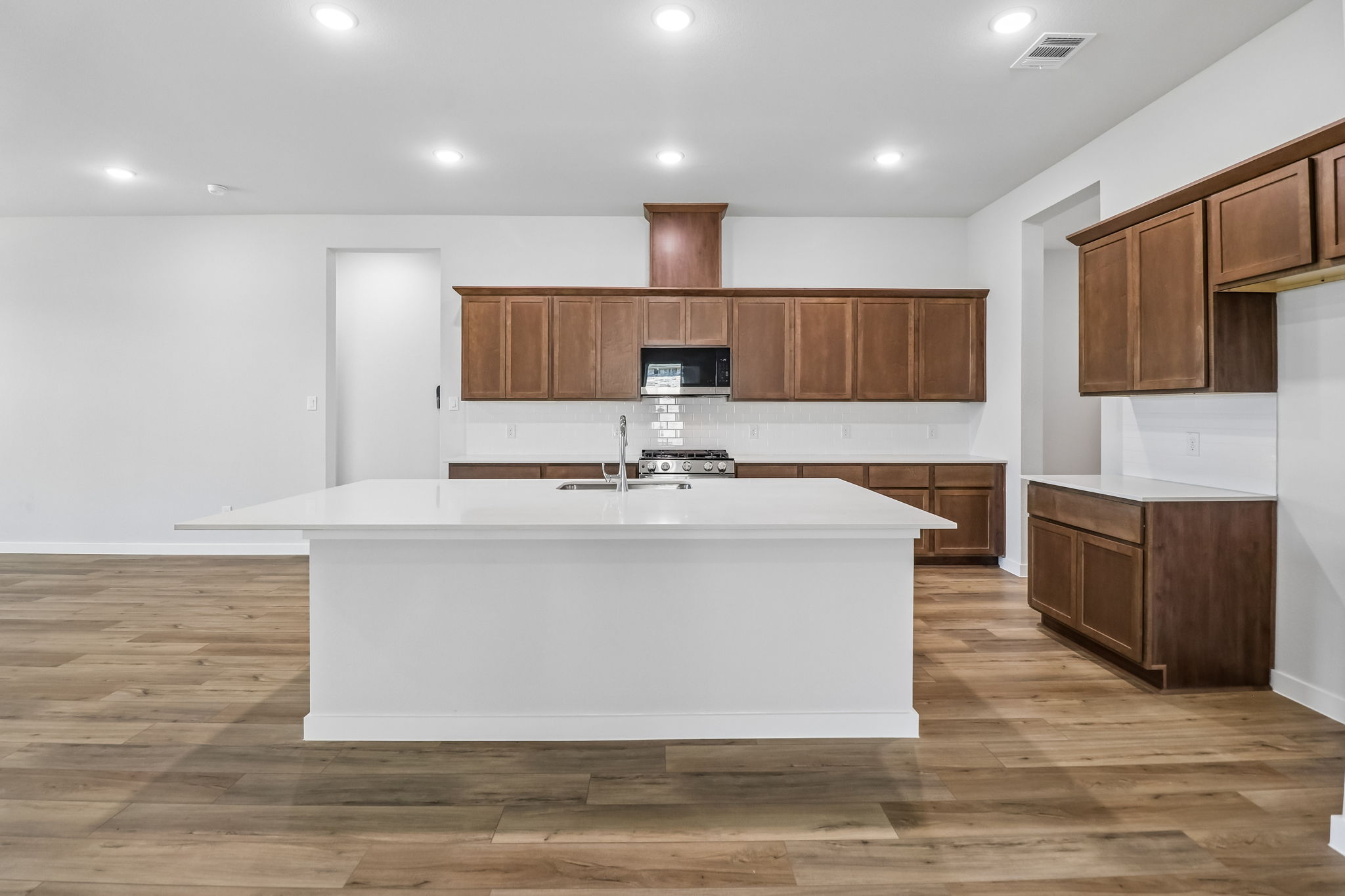 A kitchen with wooden cabinets.