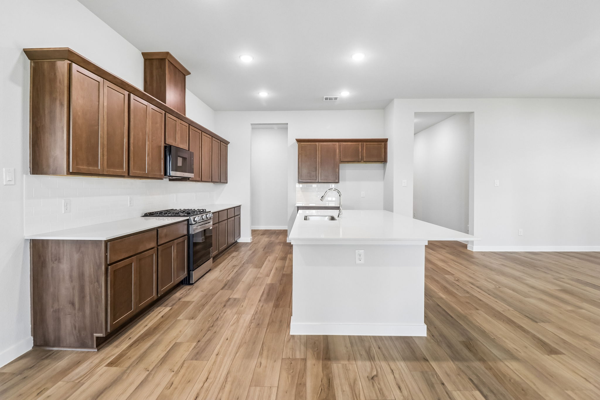 A kitchen with wooden cabinets.