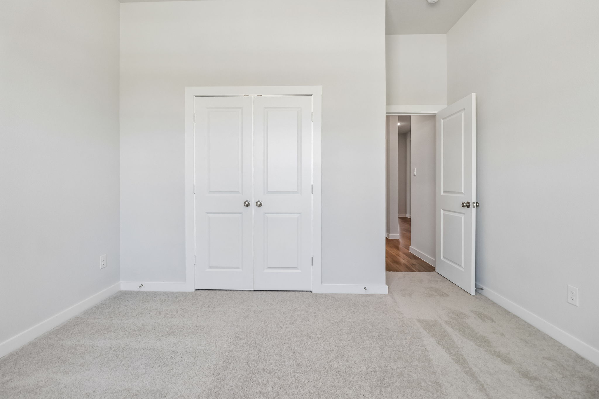 A hallway with white doors.