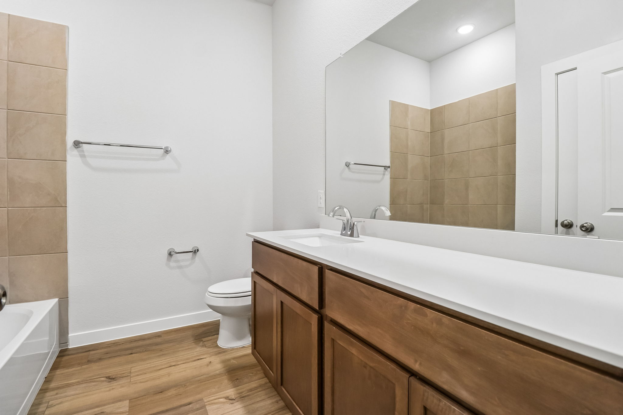 A bathroom with a tub toilet and sink.