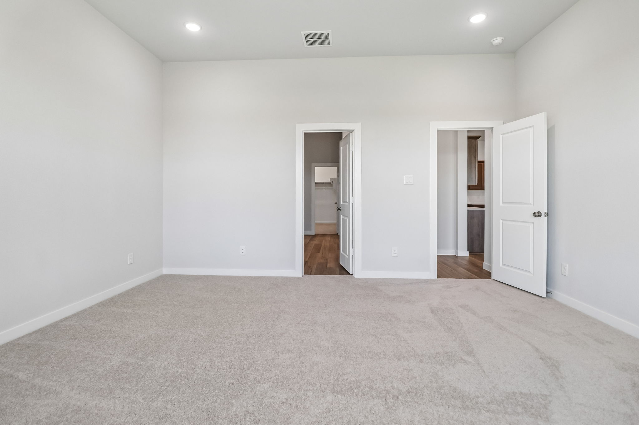 A hallway with white doors.