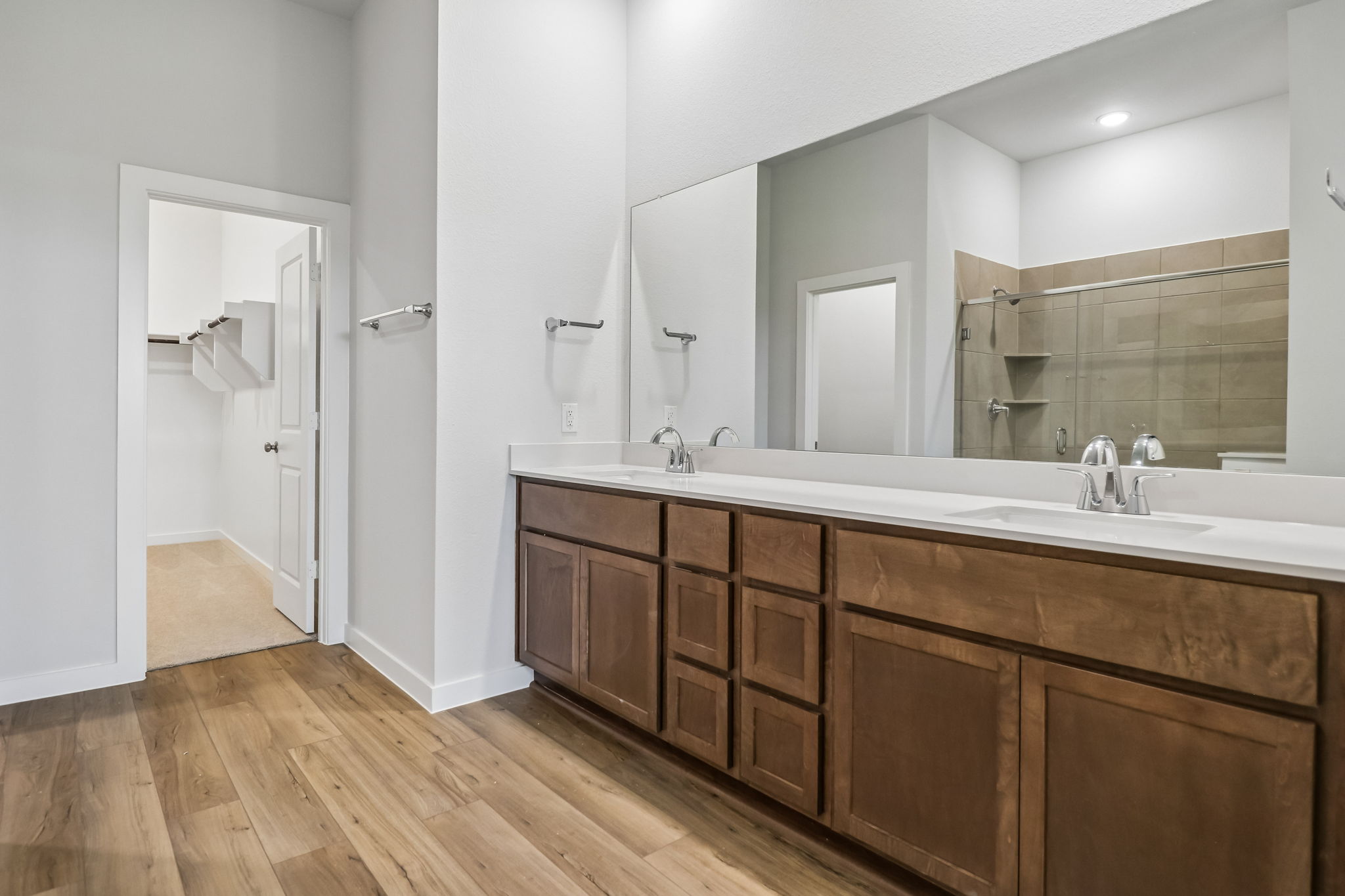 A bathroom with a large mirror.