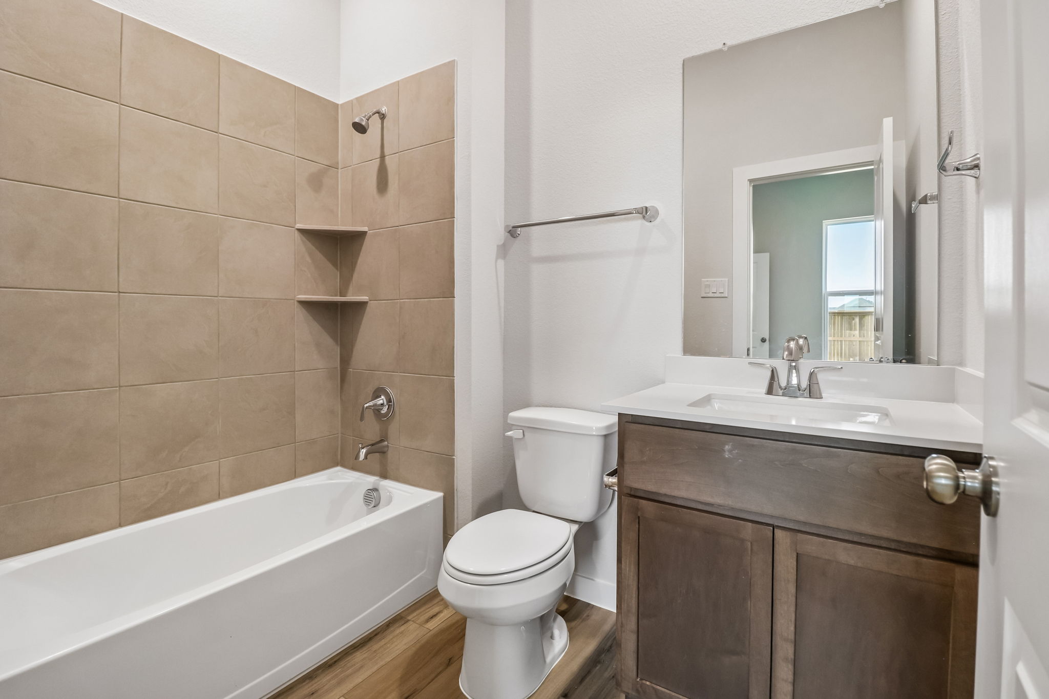A bathroom with a tub toilet and sink.