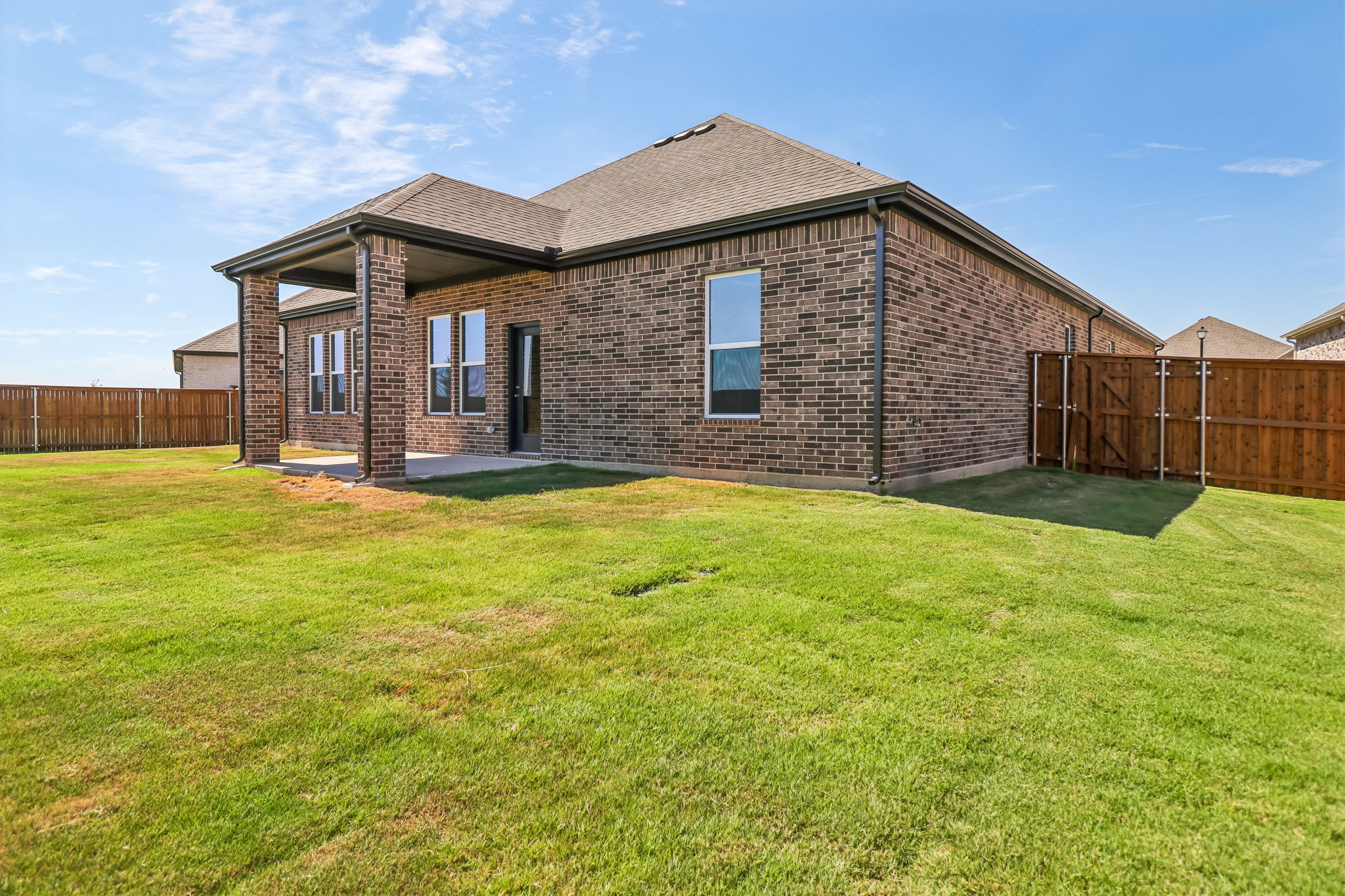 A brick house with a fence.